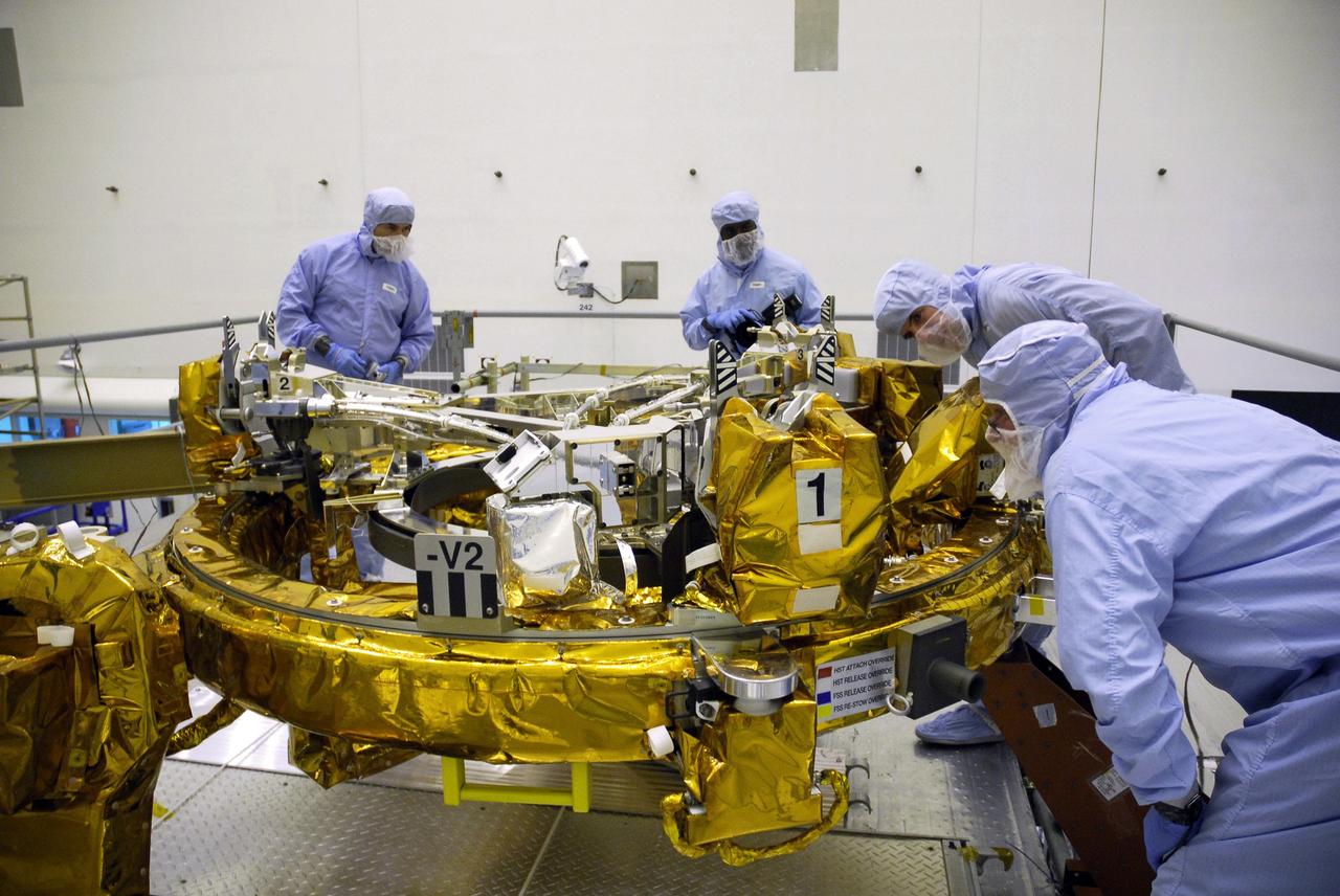 CAPE CANAVERAL, Fla. – In the Payload Hazardous Servicing Facility at NASA's Kennedy Space Center, technicians check the connections on the Soft Capture Mechanism (SCM), part of the Soft Capture and Rendezvous System, or SCRS, being mated to the Flight Support System, or FSS, carrier. The SCRS will enable the future rendezvous, capture and safe disposal of NASA's Hubble Space Telescope by either a crewed or robotic mission. The ring-like device attaches to Hubble’s aft bulkhead. The SCRS greatly increases the current shuttle capture interfaces on Hubble, therefore significantly reducing the rendezvous and capture design complexities associated with the disposal mission. The FSS will join the Multi-Use Lightweight Equipment, or MULE, carrier, the Super Lightweight Interchangeable Carrier and the Orbital Replacement Unit Carrier as payload on space shuttle Atlantis's STS-125 mission. The payload is scheduled to go to Launch Pad 39A in mid-September to be installed into Atlantis' payload bay. Atlantis is targeted to launch Oct. 8 at 1:34 a.m. EDT. Photo credit: NASA/Troy Cryder