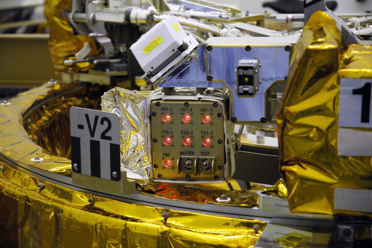 CAPE CANAVERAL, Fla. – In the Payload Hazardous Servicing Facility at NASA's Kennedy Space Center, technicians check the sensors on the Soft Capture Mechanism (SCM), part of the Soft Capture and Rendezvous System, or SCRS, after mating of the SCM to the Flight Support System, or FSS, carrier. The SCRS will enable the future rendezvous, capture and safe disposal of NASA's Hubble Space Telescope by either a crewed or robotic mission. The ring-like device attaches to Hubble’s aft bulkhead. The SCRS greatly increases the current shuttle capture interfaces on Hubble, therefore significantly reducing the rendezvous and capture design complexities associated with the disposal mission. The FSS will join the Multi-Use Lightweight Equipment, or MULE, carrier, the Super Lightweight Interchangeable Carrier and the Orbital Replacement Unit Carrier as payload on space shuttle Atlantis's STS-125 mission. The payload is scheduled to go to Launch Pad 39A in mid-September to be installed into Atlantis' payload bay. Atlantis is targeted to launch Oct. 8 at 1:34 a.m. EDT. Photo credit: NASA/Troy Cryder