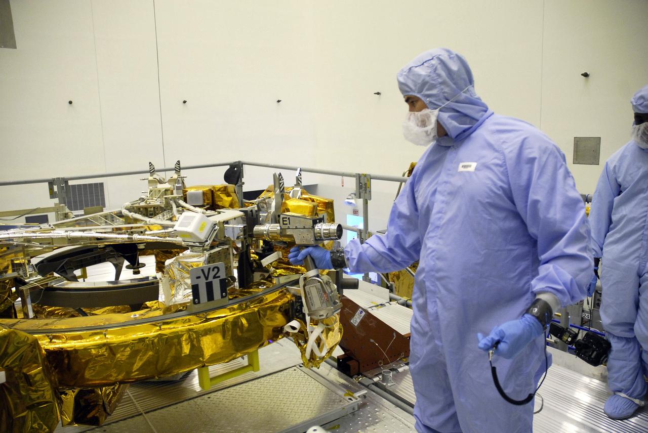 CAPE CANAVERAL, Fla. – In the Payload Hazardous Servicing Facility at NASA's Kennedy Space Center, technicians check the sensors on the Soft Capture Mechanism (SCM), part of the Soft Capture and Rendezvous System, or SCRS, after mating of the SCM to the Flight Support System, or FSS, carrier. The SCRS will enable the future rendezvous, capture and safe disposal of NASA's Hubble Space Telescope by either a crewed or robotic mission. The ring-like device attaches to Hubble’s aft bulkhead. The SCRS greatly increases the current shuttle capture interfaces on Hubble, therefore significantly reducing the rendezvous and capture design complexities associated with the disposal mission. The FSS will join the Multi-Use Lightweight Equipment, or MULE, carrier, the Super Lightweight Interchangeable Carrier and the Orbital Replacement Unit Carrier as payload on space shuttle Atlantis's STS-125 mission. The payload is scheduled to go to Launch Pad 39A in mid-September to be installed into Atlantis' payload bay. Atlantis is targeted to launch Oct. 8 at 1:34 a.m. EDT. Photo credit: NASA/Troy Cryder