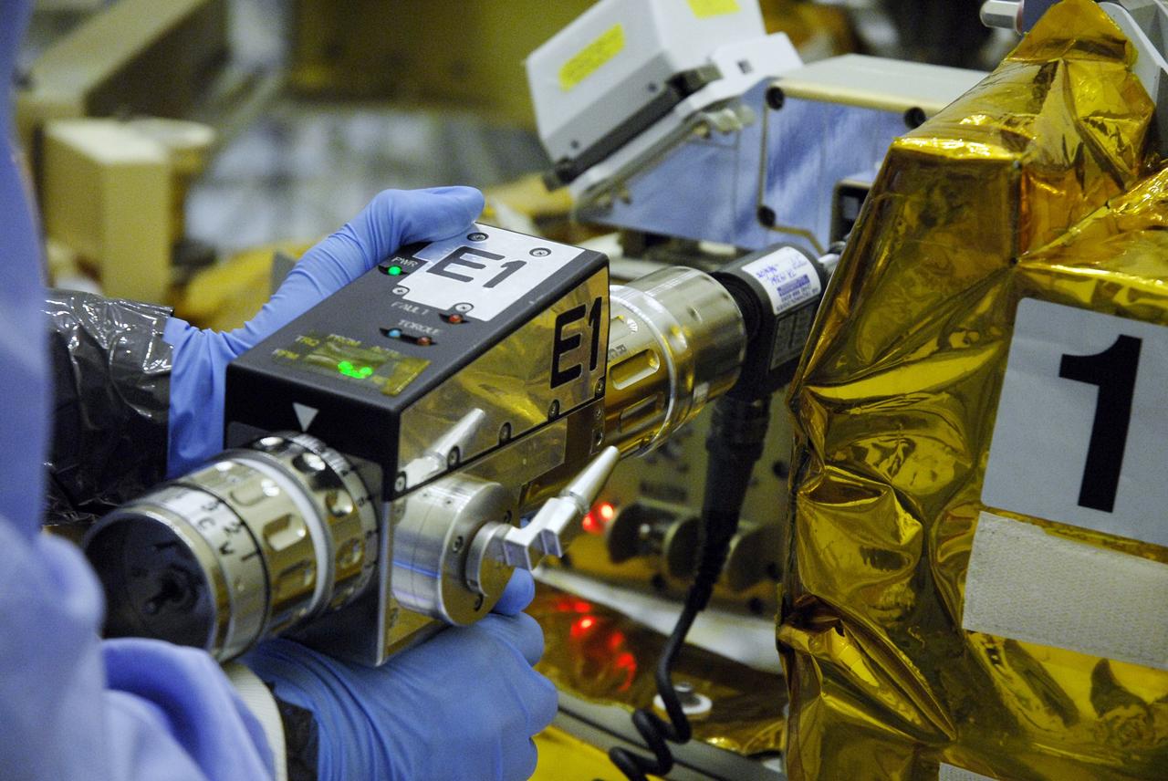 CAPE CANAVERAL, Fla. – In the Payload Hazardous Servicing Facility at NASA's Kennedy Space Center, technicians check the sensors on the Soft Capture Mechanism (SCM), part of the Soft Capture and Rendezvous System, or SCRS, after mating of the SCM to the Flight Support System, or FSS, carrier. The SCRS will enable the future rendezvous, capture and safe disposal of NASA's Hubble Space Telescope by either a crewed or robotic mission. The ring-like device attaches to Hubble’s aft bulkhead. The SCRS greatly increases the current shuttle capture interfaces on Hubble, therefore significantly reducing the rendezvous and capture design complexities associated with the disposal mission. The FSS will join the Multi-Use Lightweight Equipment, or MULE, carrier, the Super Lightweight Interchangeable Carrier and the Orbital Replacement Unit Carrier as payload on space shuttle Atlantis's STS-125 mission. The payload is scheduled to go to Launch Pad 39A in mid-September to be installed into Atlantis' payload bay. Atlantis is targeted to launch Oct. 8 at 1:34 a.m. EDT. Photo credit: NASA/Troy Cryder