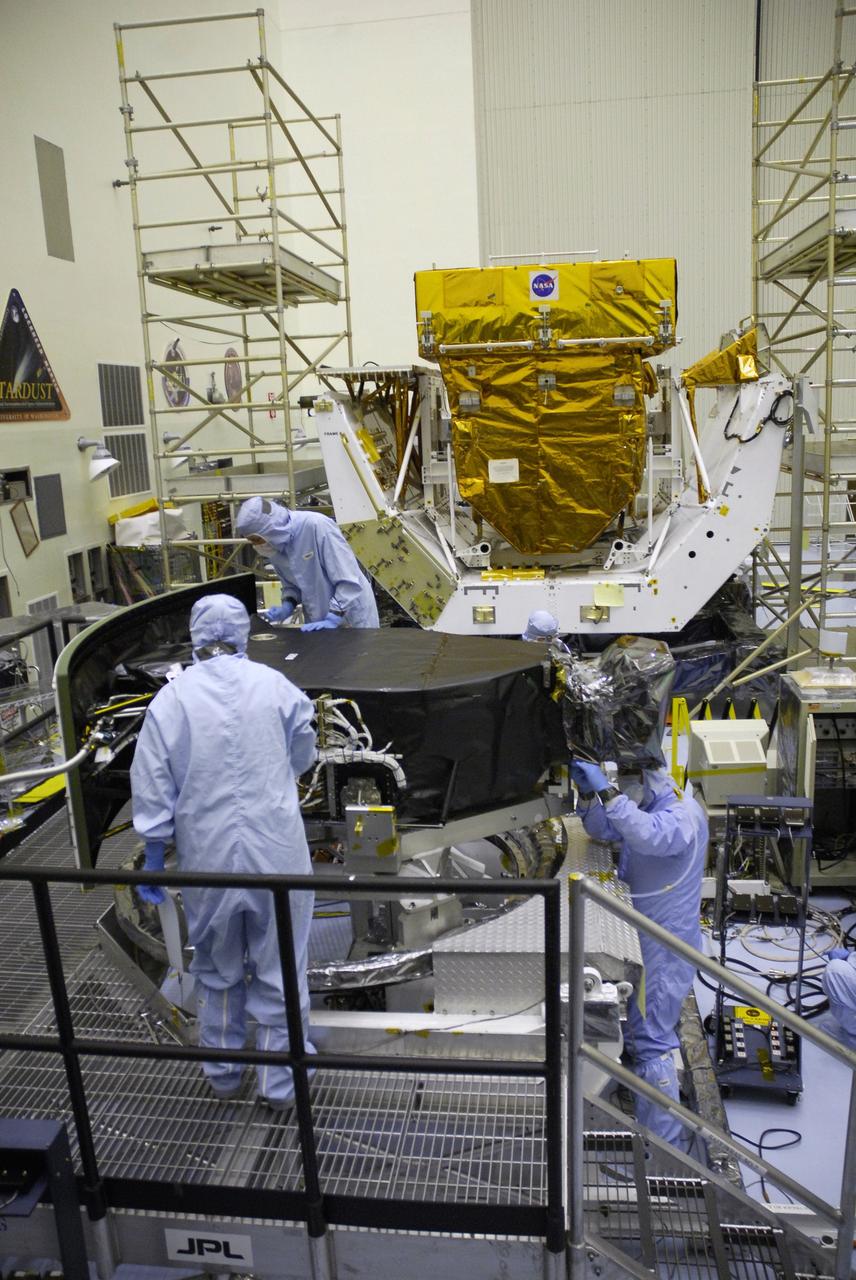 CAPE CANAVERAL, Fla. –  Technicians in the Payload Hazardous Servicing Facility complete removal of the protective cover from the Wide Field Camera 3, or WFC3.  The WFC3 is part of the payload on space shuttle Atlantis for the fifth and final Hubble servicing mission, STS-125.  As Hubble enters the last stage of its life, WFC3 will be Hubble's next evolutionary step, allowing Hubble to peer ever further into the mysteries of the cosmos. WFC3 will study a diverse range of objects and phenomena, from young and extremely distant galaxies, to much more nearby stellar systems, to objects within our very own solar system. WFC3 will take the place of Wide Field Planetary Camera 2, which astronauts will bring back to Earth aboard the shuttle. Launch of Atlantis is targeted at 1:34 a.m. EDT Oct. 8.  Photo credit: NASA/Jack Pfaller
