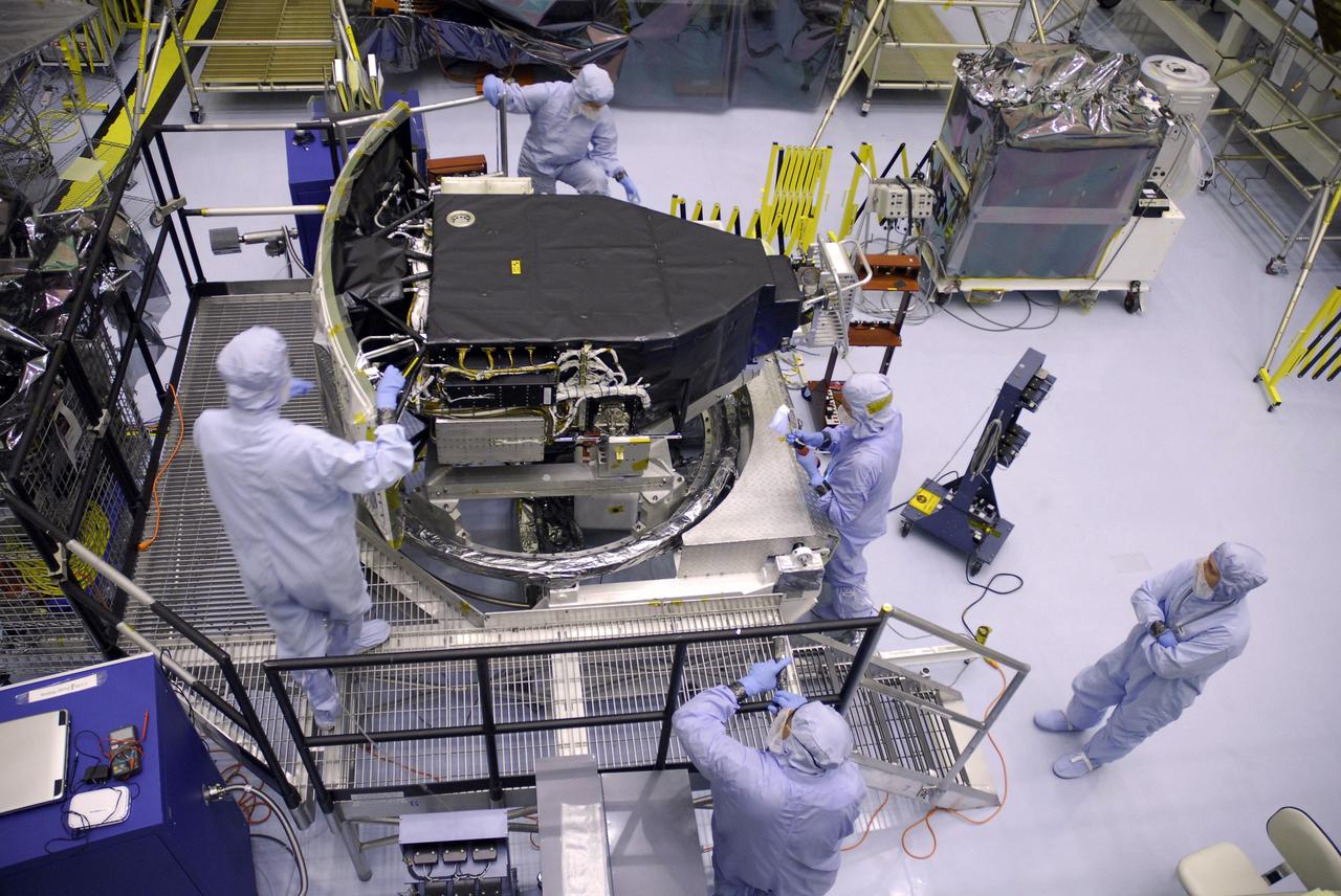 CAPE CANAVERAL, Fla. –  In the Payload Hazardous Servicing Facility at NASA's Kennedy Space Center, technicians check the Wide Field Camera 3, or WFC3, after removal of its protective cover. WFC3 is part of the payload on space shuttle Atlantis' STS-125 mission for the fifth and final Hubble servicing flight to NASA's Hubble Space Telescope.  As Hubble enters the last stage of its life, WFC3 will be Hubble's next evolutionary step, allowing Hubble to peer ever further into the mysteries of the cosmos. WFC3 will study a diverse range of objects and phenomena, from young and extremely distant galaxies, to much more nearby stellar systems, to objects within our very own solar system. WFC3 will take the place of Wide Field Planetary Camera 2, which astronauts will bring back to Earth aboard the shuttle. Launch of Atlantis is targeted at 1:34 a.m. EDT Oct. 8.  Photo credit: NASA/Amanda Diller