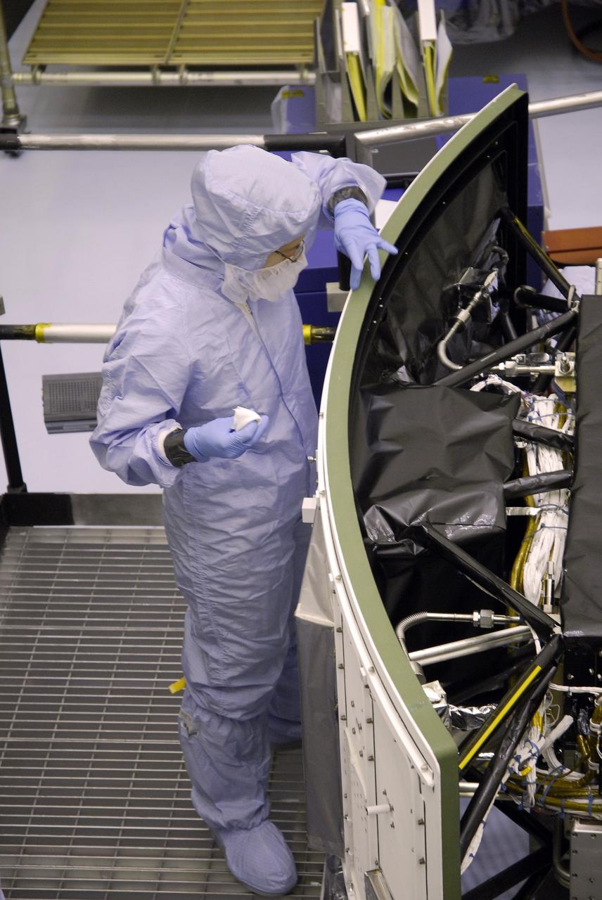CAPE CANAVERAL, Fla. –  In the Payload Hazardous Servicing Facility at NASA's Kennedy Space Center, a technician cleans the edge of the radiator on the Wide Field Camera 3, or WFC3,that will be installed on NASA's Hubble Space Telescope.  The radiator is the "outside" of WFC3 that will be exposed to space. It will expel heat out of Hubble and into space through black body radiation. WFC3 is part of the payload on space shuttle Atlantis' STS-125 mission for the fifth and final Hubble servicing flight to NASA's Hubble Space Telescope. As Hubble enters the last stage of its life, WFC3 will be Hubble's next evolutionary step, allowing Hubble to peer ever further into the mysteries of the cosmos. WFC3 will study a diverse range of objects and phenomena, from young and extremely distant galaxies, to much more nearby stellar systems, to objects within our very own solar system. WFC3 will take the place of Wide Field Planetary Camera 2, which astronauts will bring back to Earth aboard the shuttle. Launch of Atlantis is targeted at 1:34 a.m. EDT Oct. 8.  Photo credit: NASA/Amanda Diller