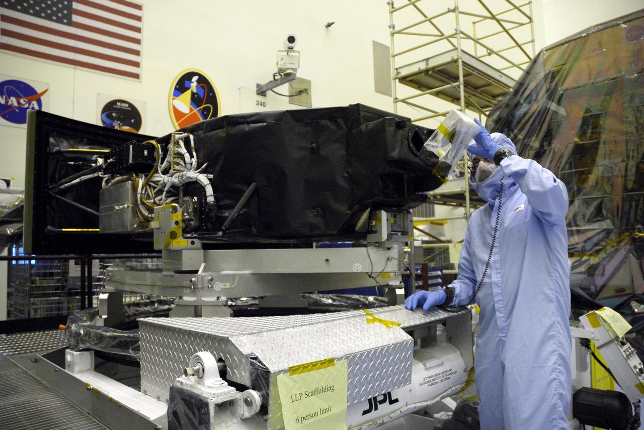CAPE CANAVERAL, Fla. –   In the Payload Hazardous Servicing Facility at NASA's Kennedy Space Center, a technician checks the pick-off mirror on the Wide Field Camera 3, or WFC3, that will be installed on NASA's Hubble Space Telescope. WFC3 is part of the payload on space shuttle Atlantis' STS-125 mission for the fifth and final Hubble servicing flight to Hubble.  As Hubble enters the last stage of its life, WFC3 will be Hubble's next evolutionary step, allowing Hubble to peer ever further into the mysteries of the cosmos. WFC3 will study a diverse range of objects and phenomena, from young and extremely distant galaxies, to much more nearby stellar systems, to objects within our very own solar system. WFC3 will take the place of Wide Field Planetary Camera 2, which astronauts will bring back to Earth aboard the shuttle. Launch of Atlantis is targeted at 1:34 a.m. EDT Oct. 8.  Photo credit: NASA/Amanda Diller