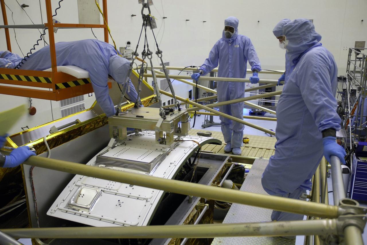 CAPE CANAVERAL, Fla. –  In the Payload Hazardous Servicing Facility at NASA's Kennedy Space Center, technicians check the placement of an overhead crane to the Wide Field Camera 3, or WFC3, that will transfer the WFC3 to the Super Lightweight Interchangeable Carrier.  WFC3 is part of the payload on space shuttle Atlantis' STS-125 mission for the fifth and final Hubble servicing flight to NASA's Hubble Space Telescope.  As Hubble enters the last stage of its life, WFC3 will be Hubble's next evolutionary step, allowing Hubble to peer ever further into the mysteries of the cosmos. WFC3 will study a diverse range of objects and phenomena, from young and extremely distant galaxies, to much more nearby stellar systems, to objects within our very own solar system. WFC3 will take the place of Wide Field Planetary Camera 2, which astronauts will bring back to Earth aboard the shuttle. Launch of Atlantis is targeted at 1:34 a.m. EDT Oct. 8.  Photo credit: NASA/Amanda Diller