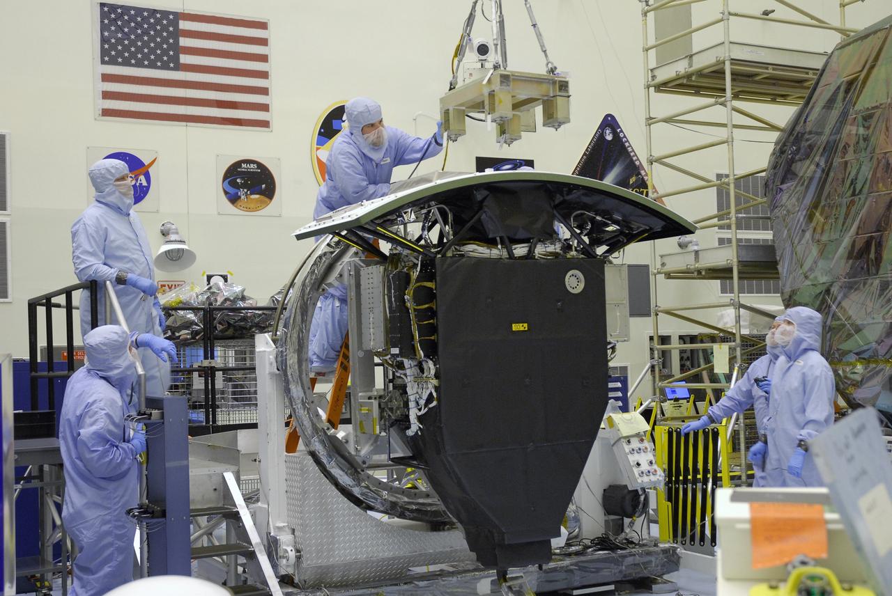 CAPE CANAVERAL, Fla. –  In the Payload Hazardous Servicing Facility at NASA's Kennedy Space Center, a technician guides a crane for attachment to the radiator on the Wide Field Camera 3, or WFC3.  The WFC3 will be transferred to the Super Lightweight Interchangeable Carrier.  WFC3 is part of the payload on space shuttle Atlantis' STS-125 mission for the fifth and final Hubble servicing flight to NASA's Hubble Space Telescope.  The radiator is the "outside" of WFC3 that will be exposed to space and will expel heat out of Hubble and into space through black body radiation.  As Hubble enters the last stage of its life, WFC3 will be Hubble's next evolutionary step, allowing Hubble to peer ever further into the mysteries of the cosmos. WFC3 will study a diverse range of objects and phenomena, from young and extremely distant galaxies, to much more nearby stellar systems, to objects within our very own solar system. WFC3 will take the place of Wide Field Planetary Camera 2, which astronauts will bring back to Earth aboard the shuttle. Launch of Atlantis is targeted at 1:34 a.m. EDT Oct. 8.  Photo credit: NASA/Amanda Diller