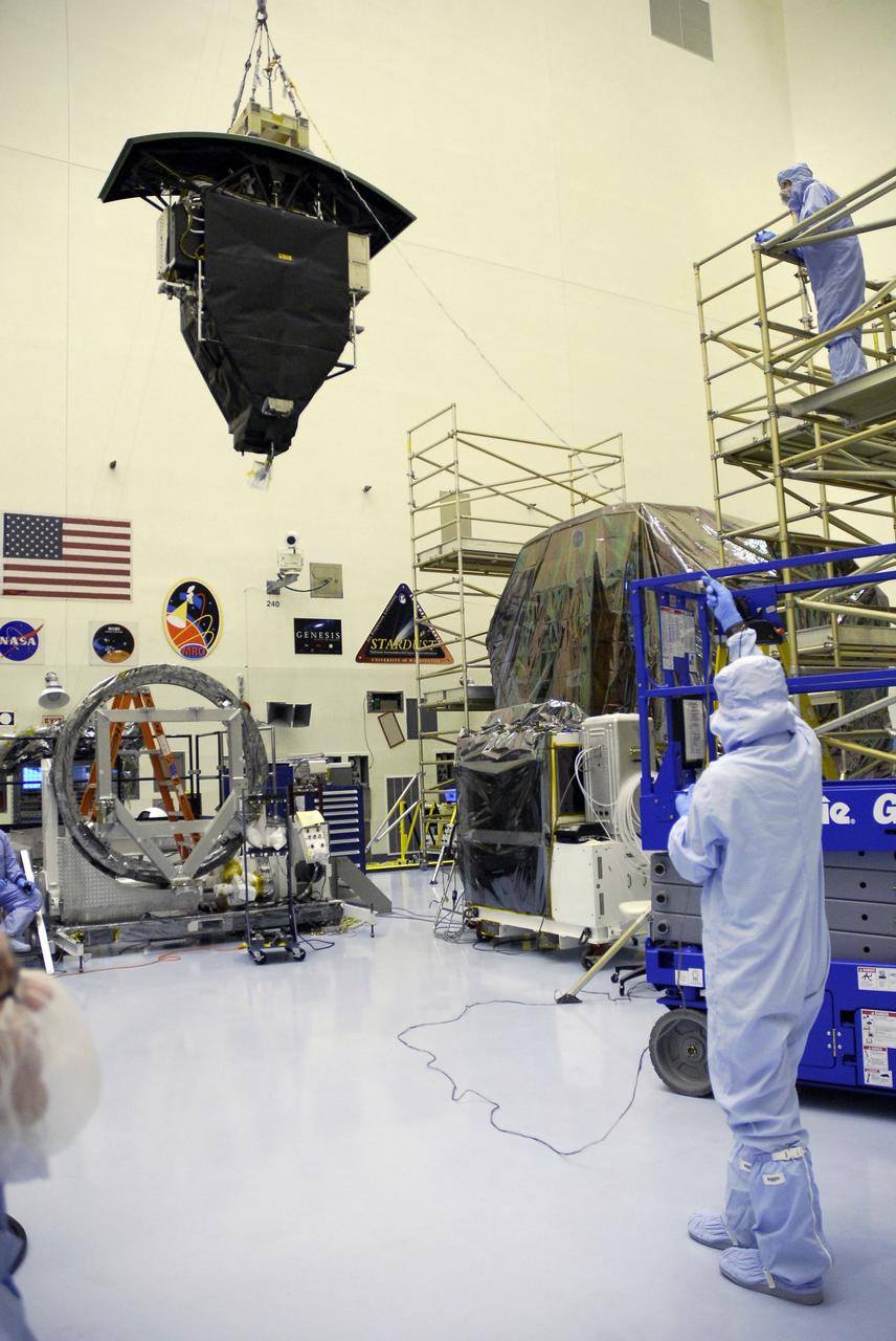 CAPE CANAVERAL, Fla. –  In the Payload Hazardous Servicing Facility at NASA's Kennedy Space Center, an overhead crane lifts the Wide Field Camera 3, or WFC3, high above the floor for transfer to the Super Lightweight Interchangeable Carrier.  WFC3 is part of the payload on space shuttle Atlantis' STS-125 mission for the fifth and final Hubble servicing flight to NASA's Hubble Space Telescope.  As Hubble enters the last stage of its life, WFC3 will be Hubble's next evolutionary step, allowing Hubble to peer ever further into the mysteries of the cosmos. WFC3 will study a diverse range of objects and phenomena, from young and extremely distant galaxies, to much more nearby stellar systems, to objects within our very own solar system. WFC3 will take the place of Wide Field Planetary Camera 2, which astronauts will bring back to Earth aboard the shuttle. Launch of Atlantis is targeted at 1:34 a.m. EDT Oct. 8.  Photo credit: NASA/Amanda Diller