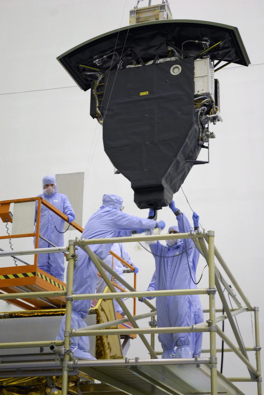 CAPE CANAVERAL, Fla. –  In the Payload Hazardous Servicing Facility at NASA's Kennedy Space Center, an overhead crane lifts the Wide Field Camera 3, or WFC3, above the stand holding the Super Lightweight Interchangeable Carrier.  WFC3 is part of the payload on space shuttle Atlantis' STS-125 mission for the fifth and final Hubble servicing flight to NASA's Hubble Space Telescope.   As Hubble enters the last stage of its life, WFC3 will be Hubble's next evolutionary step, allowing Hubble to peer ever further into the mysteries of the cosmos. WFC3 will study a diverse range of objects and phenomena, from young and extremely distant galaxies, to much more nearby stellar systems, to objects within our very own solar system. WFC3 will take the place of Wide Field Planetary Camera 2, which astronauts will bring back to Earth aboard the shuttle. Launch of Atlantis is targeted at 1:34 a.m. EDT Oct. 8.  Photo credit: NASA/Amanda Diller