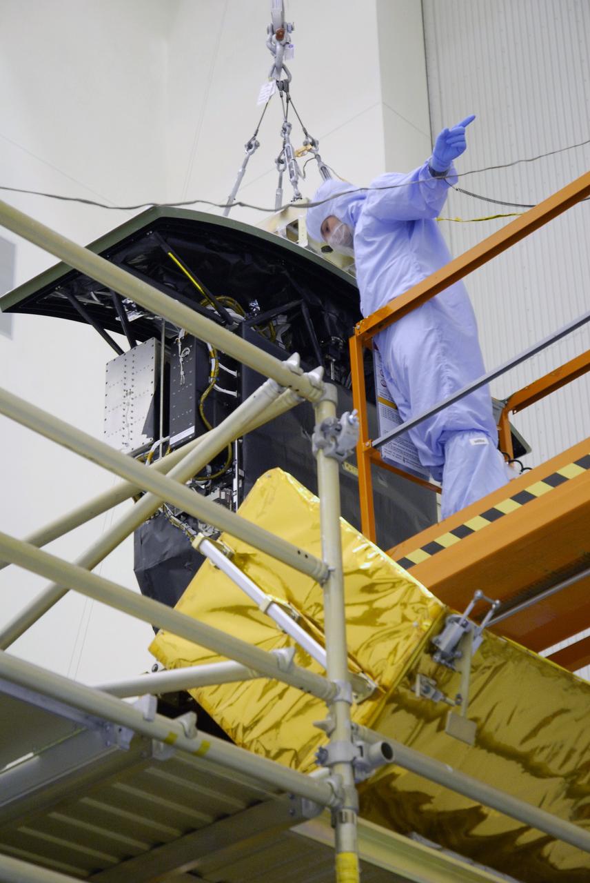 CAPE CANAVERAL, Fla. –   In the Payload Hazardous Servicing Facility at NASA's Kennedy Space Center, the Wide Field Camera 3, or WFC3, is lowered toward the Super Lightweight Interchangeable Carrier.  WFC3 is part of the payload on space shuttle Atlantis' STS-125 mission for the fifth and final Hubble servicing flight to NASA's Hubble Space Telescope.   As Hubble enters the last stage of its life, WFC3 will be Hubble's next evolutionary step, allowing Hubble to peer ever further into the mysteries of the cosmos. WFC3 will study a diverse range of objects and phenomena, from young and extremely distant galaxies, to much more nearby stellar systems, to objects within our very own solar system. WFC3 will take the place of Wide Field Planetary Camera 2, which astronauts will bring back to Earth aboard the shuttle. Launch of Atlantis is targeted at 1:34 a.m. EDT Oct. 8.  Photo credit: NASA/Amanda Diller