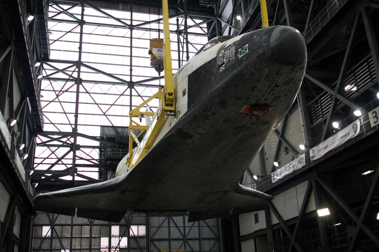 CAPE CANAVERAL, Fla. – In the Vehicle Assembly Building transfer aisle at NASA's Kennedy Space Center, the overhead crane lifts space shuttle Atlantis high above its transporter. Atlantis will be raised to vertical for transfer to high bay 3. There it will be stacked with its external fuel tank and twin solid rocket boosters. After additional preparations are made, the shuttle will be rolled out to Launch Pad 39A to prepare for launch on the STS-125 mission targeted for 1:34 a.m. EDT Oct. 8. Photo credit: NASA/Dimitri Gerondidakis