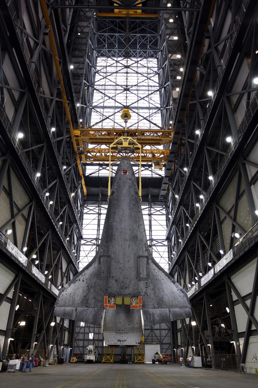CAPE CANAVERAL, Fla. –  In the Vehicle Assembly Building at NASA's Kennedy Space Center, space shuttle Atlantis is suspended vertically above the transfer aisle. The view shows the underbelly of the shuttle.  Atlantis will be lifted into high bay 3 and stacked with its external fuel tank and twin solid rocket boosters. After additional preparations are made, the shuttle will be rolled out to Launch Pad 39A to prepare for launch on the STS-125 mission targeted for 1:34 a.m. EDT Oct. 8. Photo credit: NASA/Dimitri Gerondidakis