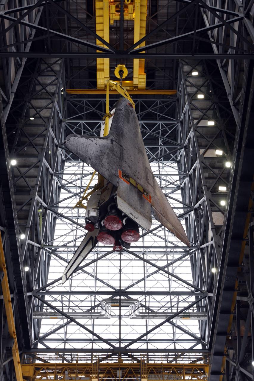 CAPE CANAVERAL, Fla. – A crane lifts space shuttle Atlantis higher into the upper levels of the Vehicle Assembly Building at NASA's Kennedy Space Center. The shuttle will be moved into high bay 3 and lowered for stacking with its external fuel tank and twin solid rocket boosters. After additional preparations are made, the shuttle will be rolled out to Launch Pad 39A to prepare for launch on the STS-125 mission targeted for 1:34 a.m. EDT Oct. 8. Photo credit: NASA/Dimitri Gerondidakis