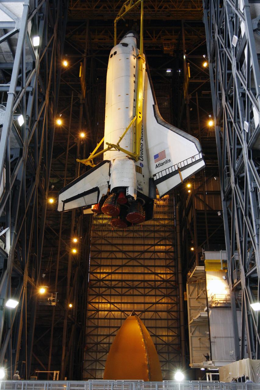 CAPE CANAVERAL, Fla. –  In the Vehicle Assembly Building at NASA's Kennedy Space Center, space shuttle Atlantis is lowered toward the external fuel tank in high bay 3.  Atlantis will be mated to the tank and twin solid rocket boosters stacked on the mobile launcher platform.  After additional preparations are made, the shuttle will be rolled out to Launch Pad 39A to prepare for launch on the STS-125 mission targeted for 1:34 a.m. EDT Oct. 8. Photo credit: NASA/Dimitri Gerondidakis