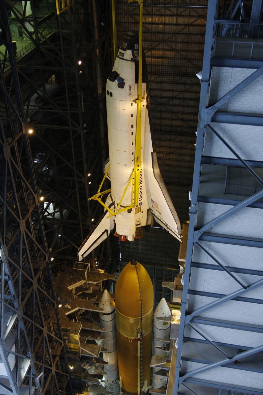 CAPE CANAVERAL, Fla. – In the Vehicle Assembly Building at NASA's Kennedy Space Center, space shuttle Atlantis is lowered toward the external fuel tank and twin solid rocket boosters in high bay 3. Atlantis will be mated to the tank and boosters stacked on the mobile launcher platform. After additional preparations are made, the shuttle will be rolled out to Launch Pad 39A to prepare for launch on the STS-125 mission targeted for 1:34 a.m. EDT Oct. 8. Photo credit: NASA/Dimitri Gerondidakis