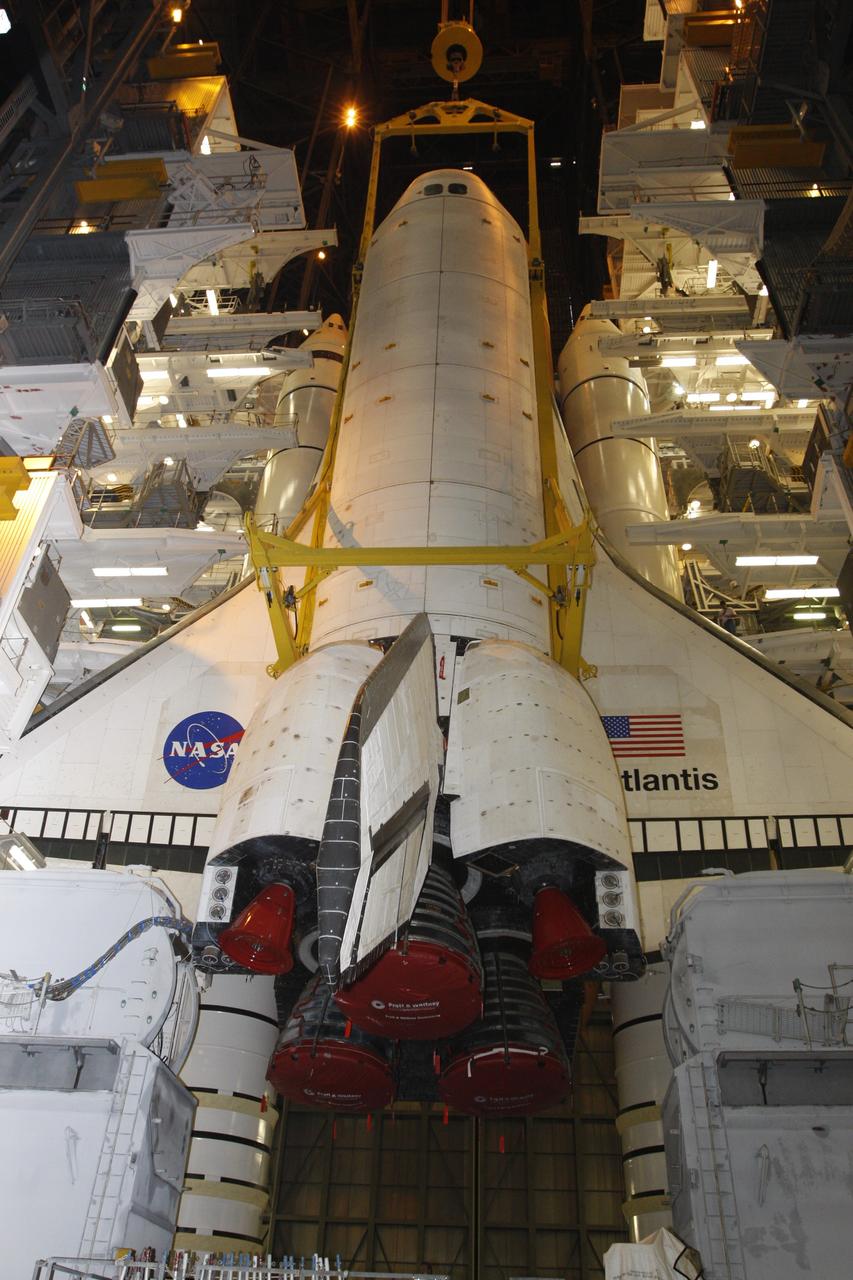 CAPE CANAVERAL, Fla. – In the Vehicle Assembly Building at NASA's Kennedy Space Center, space shuttle Atlantis approaches the floor of the mobile launcher platform in high bay 3. Behind the shuttle are the external fuel tank and twin solid rocket boosters already stacked there. Atlantis will be mated to the tank and boosters. After additional preparations are made, the shuttle will be rolled out to Launch Pad 39A to prepare for launch on the STS-125 mission targeted for 1:34 a.m. EDT Oct. 8. Photo credit: NASA/Dimitri Gerondidakis