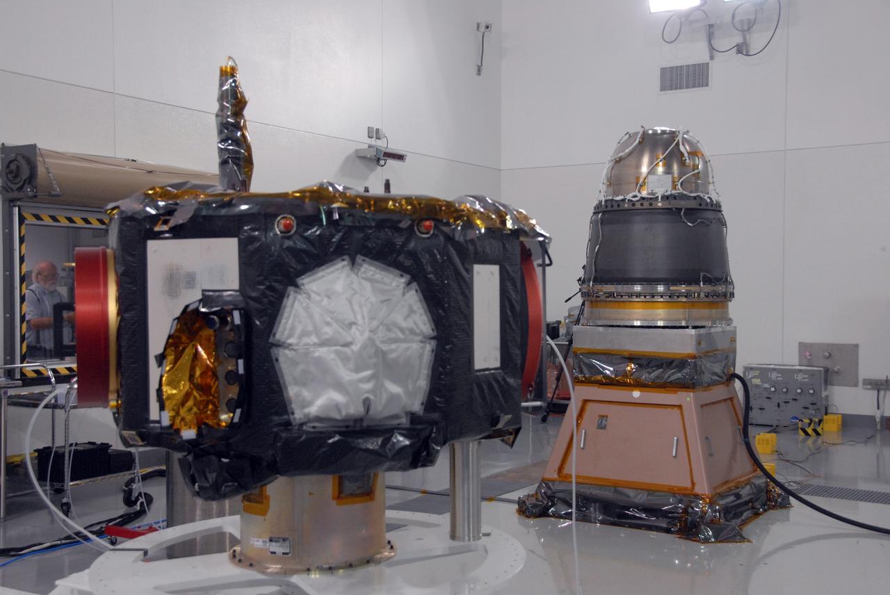VANDENBERG AIR FORCE BASE, Calif. - At Vandenberg Air Force Base in California, at left is the NASA's Interstellar Boundary Explorer, or IBEX, spacecraft. At right are the Star-27 kick motor and nozzle for IBEX “on top” and the adapter cone, part of the IBEX flight system, underneath. The IBEX is being prepared for a spin balance test. The IBEX satellite will make the first map of the boundary between the Solar System and interstellar space. IBEX is the first mission designed to detect the edge of the Solar System. As the solar wind from the sun flows out beyond Pluto, it collides with the material between the stars, forming a shock front. IBEX contains two neutral atom imagers designed to detect particles from the termination shock at the boundary between the Solar System and interstellar space. IBEX also will study galactic cosmic rays, energetic particles from beyond the Solar System that pose a health and safety hazard for humans exploring beyond Earth orbit. IBEX will make these observations from a highly elliptical orbit that takes it beyond the interference of the Earth's magnetosphere. IBEX is targeted for launch from a Pegasus XL rocket on Oct. 5. Photo credit: NASA/VAFB