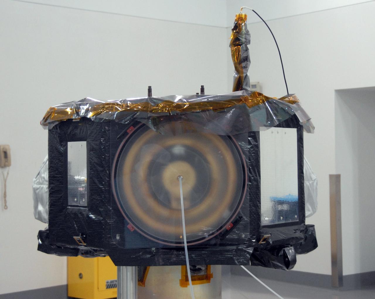 VANDENBERG AIR FORCE BASE, Calif. - At Vandenberg Air Force Base in California, the NASA's Interstellar Boundary Explorer, or IBEX, spacecraft seen here is being prepared for a spin balance test. The IBEX satellite will make the first map of the boundary between the Solar System and interstellar space. IBEX is the first mission designed to detect the edge of the Solar System. As the solar wind from the sun flows out beyond Pluto, it collides with the material between the stars, forming a shock front. IBEX contains two neutral atom imagers designed to detect particles from the termination shock at the boundary between the Solar System and interstellar space. IBEX also will study galactic cosmic rays, energetic particles from beyond the Solar System that pose a health and safety hazard for humans exploring beyond Earth orbit. IBEX will make these observations from a highly elliptical orbit that takes it beyond the interference of the Earth's magnetosphere. IBEX is targeted for launch from a Pegasus XL rocket on Oct. 5. Photo credit: NASA/VAFB