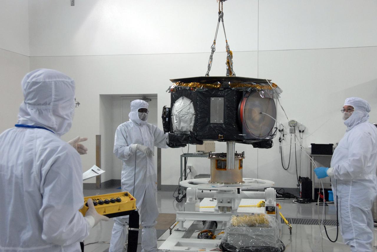VANDENBERG AIR FORCE BASE, Calif. - At Vandenberg Air Force Base in California, the NASA's Interstellar Boundary Explorer, or IBEX, spacecraft is lifted toward a spin stand (behind it) for testing. The IBEX satellite will make the first map of the boundary between the Solar System and interstellar space. IBEX is the first mission designed to detect the edge of the Solar System. As the solar wind from the sun flows out beyond Pluto, it collides with the material between the stars, forming a shock front. IBEX contains two neutral atom imagers designed to detect particles from the termination shock at the boundary between the Solar System and interstellar space. IBEX also will study galactic cosmic rays, energetic particles from beyond the Solar System that pose a health and safety hazard for humans exploring beyond Earth orbit. IBEX will make these observations from a highly elliptical orbit that takes it beyond the interference of the Earth's magnetosphere. IBEX is targeted for launch from a Pegasus XL rocket on Oct. 5. Photo credit: NASA/VAFB