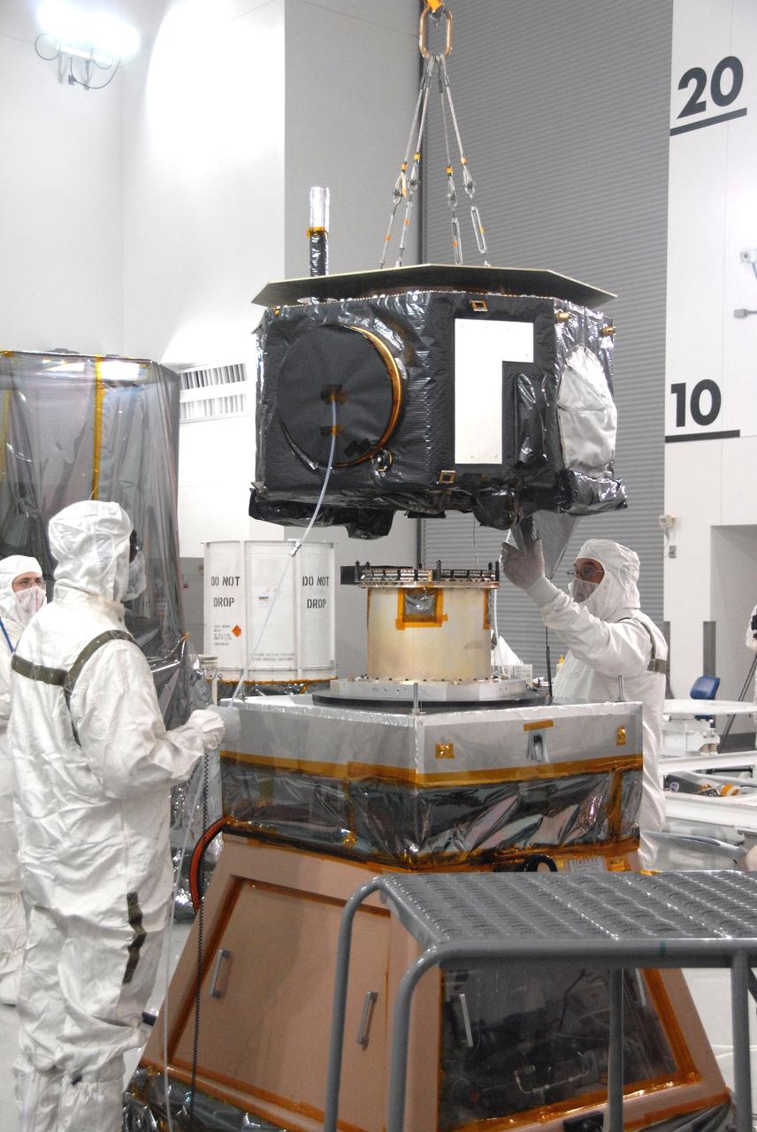 VANDENBERG AIR FORCE BASE, Calif. - At Vandenberg Air Force Base in California, a technician helps guide the placement of NASA's Interstellar Boundary Explorer, or IBEX, spacecraft onto a stand for spin balance testing. The IBEX satellite will make the first map of the boundary between the Solar System and interstellar space. IBEX is the first mission designed to detect the edge of the Solar System. As the solar wind from the sun flows out beyond Pluto, it collides with the material between the stars, forming a shock front. IBEX contains two neutral atom imagers designed to detect particles from the termination shock at the boundary between the Solar System and interstellar space. IBEX also will study galactic cosmic rays, energetic particles from beyond the Solar System that pose a health and safety hazard for humans exploring beyond Earth orbit. IBEX will make these observations from a highly elliptical orbit that takes it beyond the interference of the Earth's magnetosphere. IBEX is targeted for launch from a Pegasus XL rocket on Oct. 5. Photo credit: NASA/VAFB