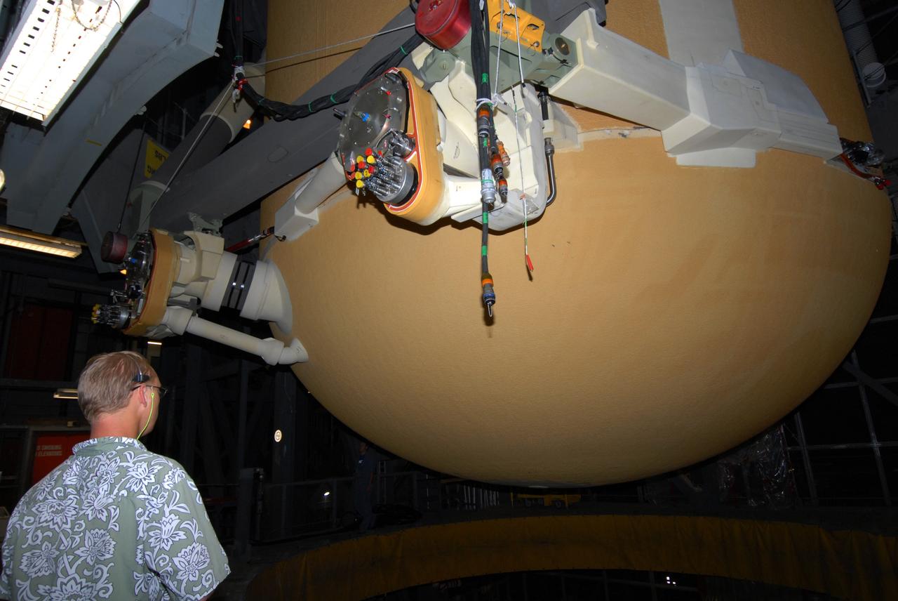 CAPE CANAVERAL, Fla. –   In the Vehicle Assembly Building at NASA's Kennedy Space Center, a worker keeps watch as external fuel tank 129 is lifted out of the checkout cell to high bay 1 where it will be mated with the solid rocket boosters. The external tank-SRB stack will be mated in two weeks to space shuttle Endeavour for the STS-126 mission.  The STS-126 mission will deliver a Multi-Purpose Logistics Module to the International Space Station.  Launch is targeted for Nov. 10. Photo credit: NASA/Jack Pfaller