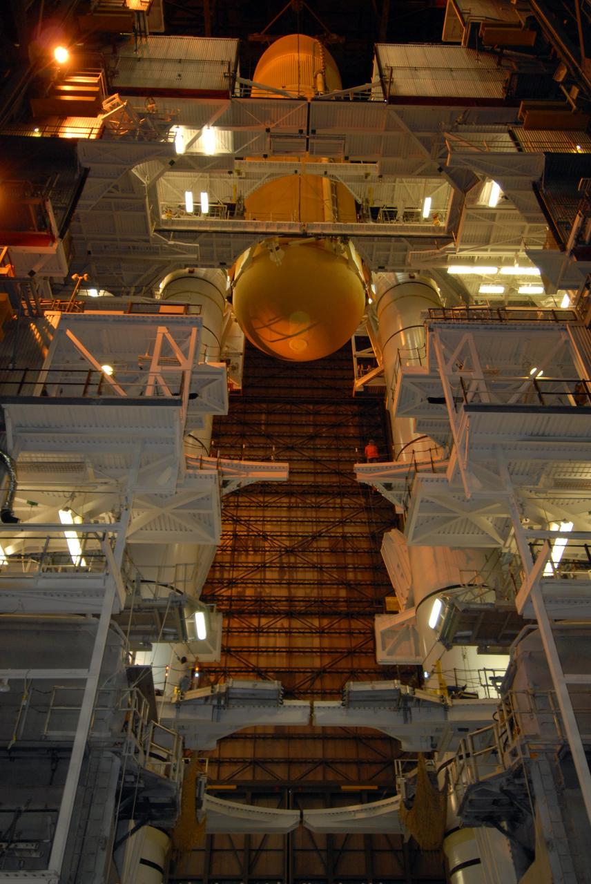 CAPE CANAVERAL, Fla. –   In the Vehicle Assembly Building at NASA's Kennedy Space Center, external fuel tank 129 is lowered into high bay 1 between the solid rocket boosters for mating on the mobile launcher platform. The external tank-SRB stack will then be mated in two weeks to space shuttle Endeavour for the STS-126 mission.  The STS-126 mission will deliver a Multi-Purpose Logistics Module to the International Space Station.  Launch is targeted for Nov. 10. Photo credit: NASA/Jack Pfaller
