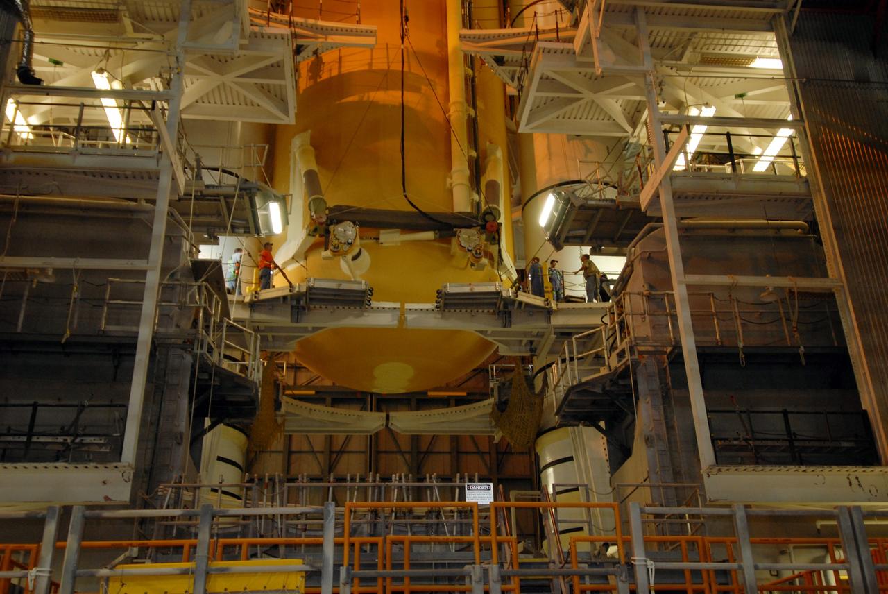 CAPE CANAVERAL, Fla. –  –  In the Vehicle Assembly Building at NASA's Kennedy Space Center, external fuel tank 129 is lowered between the solid rocket boosters for mating on the mobile launcher platform in high bay 1. The external tank-SRB stack will then be mated in two weeks to space shuttle Endeavour for the STS-126 mission.  The STS-126 mission will deliver a Multi-Purpose Logistics Module to the International Space Station.  Launch is targeted for Nov. 10. Photo credit: NASA/Jack Pfaller