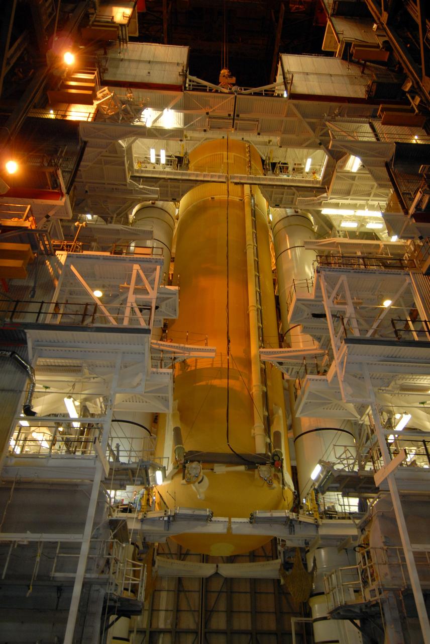 CAPE CANAVERAL, Fla. – In the Vehicle Assembly Building at NASA's Kennedy Space Center, external fuel tank 129 is lowered between the solid rocket boosters for mating on the mobile launcher platform in high bay 1. The external tank-SRB stack will then be mated in two weeks to space shuttle Endeavour for the STS-126 mission. The STS-126 mission will deliver a Multi-Purpose Logistics Module to the International Space Station. Launch is targeted for Nov. 10. Photo credit: NASA/Jack Pfaller