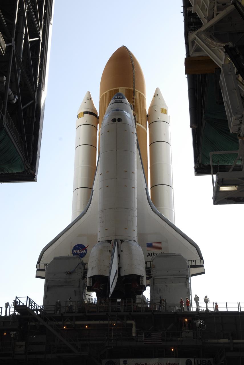 CAPE CANAVERAL, Fla. – Space shuttle Atlantis clears the open doorway of the Vehicle Assembly Building at NASA’s Kennedy Space Center as it rolls out to Launch Pad 39A. The shuttle stack, with solid rocket boosters and external fuel tank attached to Atlantis, rest on the mobile launcher platform.  Movement is provided by the crawler-transporter underneath.  First motion occurred at 9:19 a.m. EDT. The Sept. 2 rollout date was postponed due to Tropical Storm Hanna’s shift to a northern track. Atlantis is scheduled to launch on the STS-125 mission to service NASA’s Hubble Space Telescope.  Launch is targeted for Oct. 8.  Photo credit: NASA/Kim Shiflett