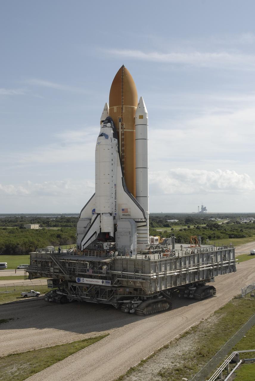 CAPE CANAVERAL, Fla. –  Space shuttle Atlantis rolls along the crawlerway toward Launch pad 39A after leaving the Vehicle Assembly Building at NASA’s Kennedy Space Center. The shuttle stack, with solid rocket boosters and external fuel tank attached to Atlantis, rest on the mobile launcher platform.  Movement is provided by the crawler-transporter underneath.  First motion occurred at 9:19 a.m. EDT. The Sept. 2 rollout date was postponed due to Tropical Storm Hanna’s shift to a northern track. Atlantis is scheduled to launch on the STS-125 mission to service NASA’s Hubble Space Telescope.  Launch is targeted for Oct. 8.  Photo credit: NASA/Kim Shiflett