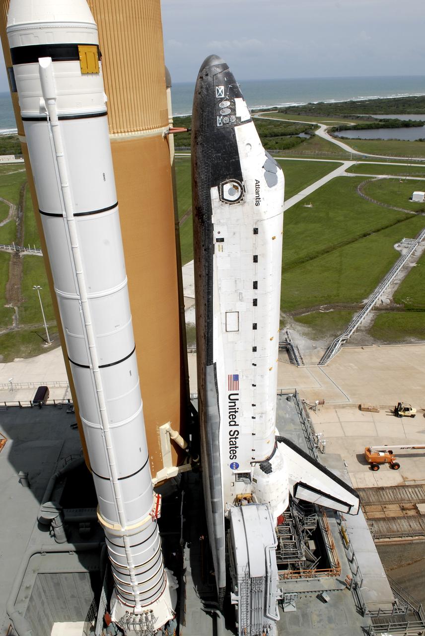 CAPE CANAVERAL, Fla. –  Space shuttle Atlantis comes to a stop on the top of Launch Pad 39A at NASA's Kennedy Space Center after more than a 6-hour journey from the Vehicle Assembly Building. First motion occurred at 9:19 a.m. EDT and Atlantis was hard down on the pad at 3:52 p.m.. The shuttle stack, with solid rocket boosters and external fuel tank attached to Atlantis, rest on the mobile launcher platform.  Movement is provided by the crawler-transporter underneath.  The Sept. 2 rollout date was postponed due to Tropical Storm Hanna’s shift to a northern track. Atlantis is scheduled to launch on the STS-125 mission to service NASA’s Hubble Space Telescope.  Launch is targeted for Oct. 8.  Photo credit: NASA/Kim Shiflett