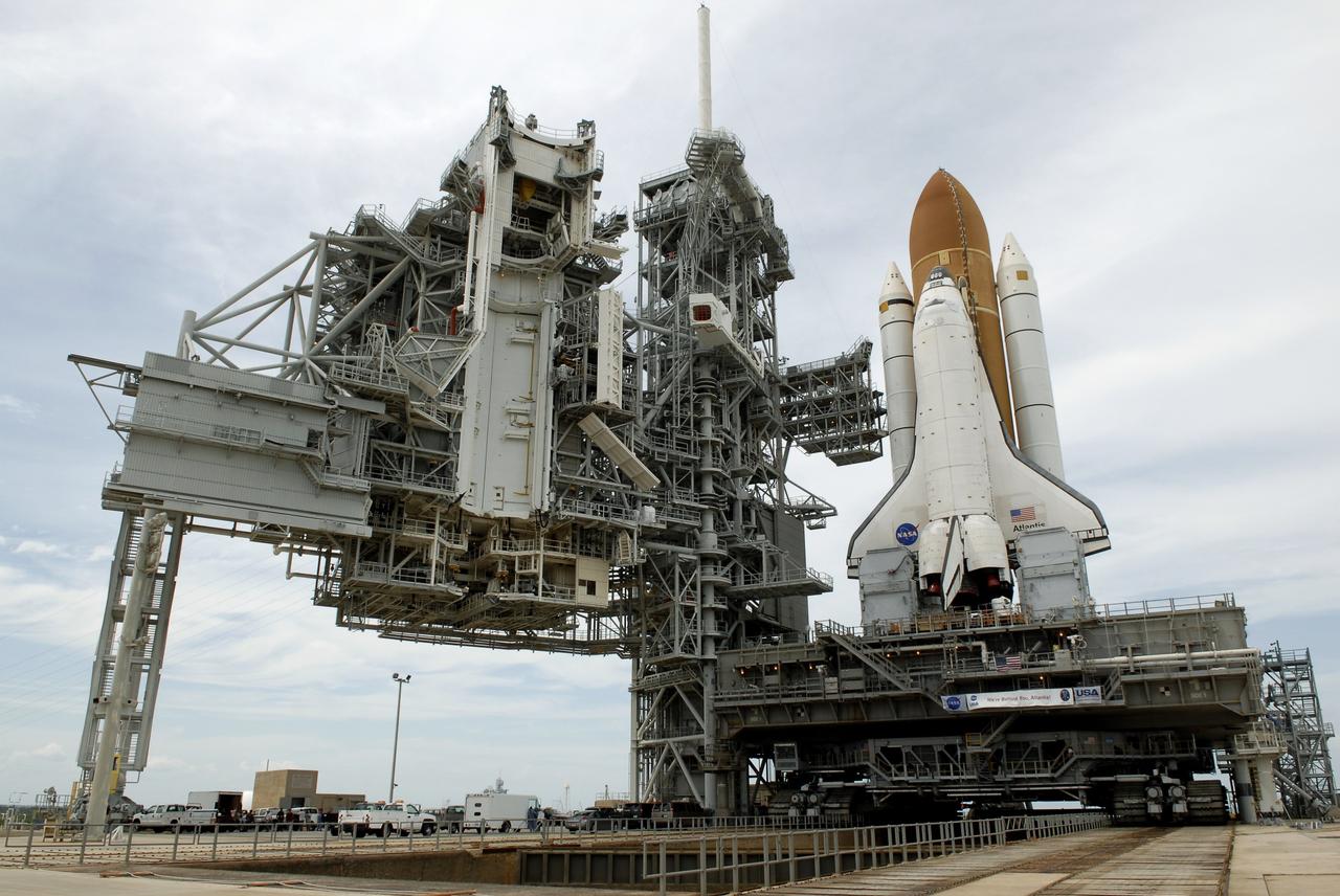 CAPE CANAVERAL, Fla. – Space shuttle Atlantis comes to a stop on the top of Launch Pad 39A at NASA's Kennedy Space Center after more than a 6-hour journey from the Vehicle Assembly Building. First motion occurred at 9:19 a.m. EDT and Atlantis was hard down on the pad at 3:52 p.m. At far left is the rotating service structure that will be rotated to enclose the shuttle for launch preparations. The shuttle stack, with solid rocket boosters and external fuel tank attached to Atlantis, rest on the mobile launcher platform. Movement is provided by the crawler-transporter underneath. The Sept. 2 rollout date was postponed due to Tropical Storm Hanna’s shift to a northern track. Atlantis is scheduled to launch on the STS-125 mission to service NASA’s Hubble Space Telescope. Launch is targeted for Oct. 8. Photo credit: NASA/Kim Shiflett