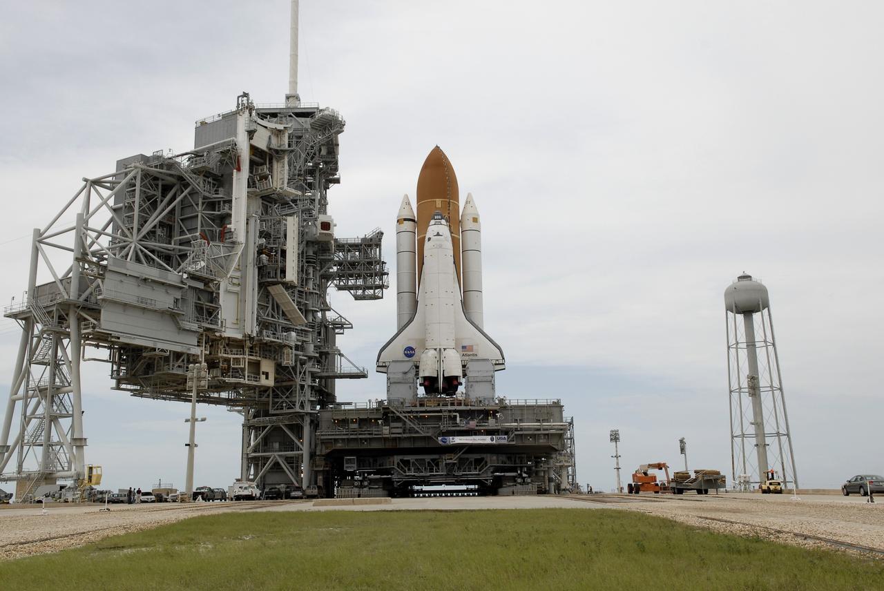 CAPE CANAVERAL, Fla. – Space shuttle Atlantis comes to a stop on the top of Launch Pad 39A at NASA's Kennedy Space Center after more than a 6-hour journey from the Vehicle Assembly Building. First motion occurred at 9:19 a.m. EDT and Atlantis was hard down on the pad at 3:52 p.m. At far left is the rotating service structure that will be rotated to enclose the shuttle for launch preparations. The shuttle stack, with solid rocket boosters and external fuel tank attached to Atlantis, rest on the mobile launcher platform. Movement is provided by the crawler-transporter underneath. The Sept. 2 rollout date was postponed due to Tropical Storm Hanna’s shift to a northern track. Atlantis is scheduled to launch on the STS-125 mission to service NASA’s Hubble Space Telescope. Launch is targeted for Oct. 8. Photo credit: NASA/Kim Shiflett