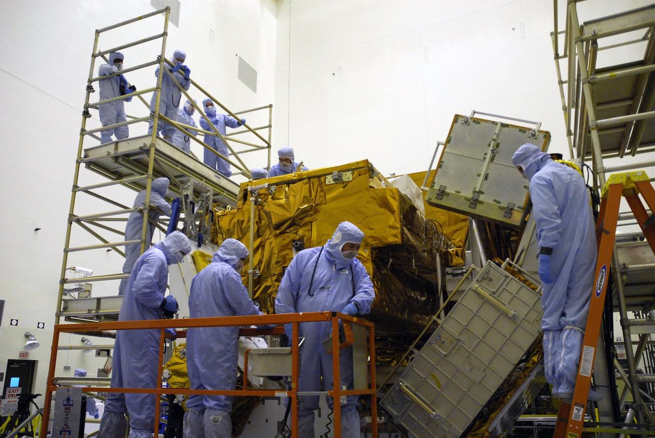 CAPE CANAVERAL, Fla. –  In the Payload Hazardous Servicing Facility at NASA’s Kennedy Space Center, crew members with the STS-125 mission get a close look at some of the equipment associated with their mission to service NASA’s Hubble Space Telescope. In front, Mission Specialists Mike Massimino and John Grunsfeld are on a lift that will allow them to look at Axial Science Instrument Protective Enclosure, or ASIPE, interfaces.  On the stand at the top left are an HST inspector, Johnson Space Center EVA Trainers Kristie Hansen and Thomas Gonzales Torres, and Mission Specialist Michael Good. The STS-125 crew is taking part in a crew equipment interface test, which provides experience handling tools, equipment and hardware they will use on their mission.  Space shuttle Atlantis is targeted to launch on the STS-125 mission Oct. 10. Photo credit: NASA/Kim Shiflett