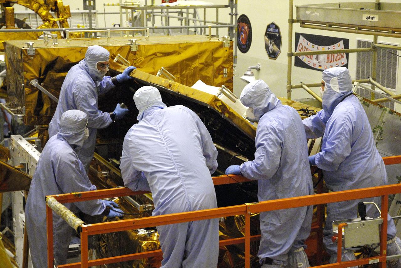 CAPE CANAVERAL, Fla. – In the Payload Hazardous Servicing Facility at NASA’s Kennedy Space Center, crew members with the STS-125 mission get a close look at some of the equipment associated with their mission to service NASA’s Hubble Space Telescope. In the foreground, center, are Mission Specialists Mike Massimino and Michael Good, looking at the box containing the Cosmic Origins Spectrograph, or COS, on the orbital replacement unit carrier. COS will be the most sensitive ultraviolet spectrograph ever flown on Hubble and will probe the "cosmic web" - the large-scale structure of the universe whose form is determined by the gravity of dark matter and is traced by galaxies and intergalactic gas. The STS-125 crew is taking part in a crew equipment interface test, which provides experience handling tools, equipment and hardware they will use on their mission. Space shuttle Atlantis is targeted to launch on the STS-125 mission Oct. 10. Photo credit: NASA/Kim Shiflett
