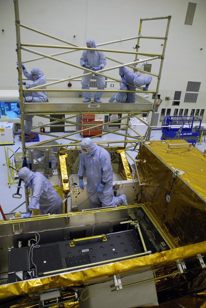 CAPE CANAVERAL, Fla. –  In the Payload Hazardous Servicing Facility at NASA’s Kennedy Space Center, crew members with the STS-125 mission get a close look at some of the equipment associated with their mission to service NASA’s Hubble Space Telescope.  Looking at the box containing the Cosmic Origins Spectrograph, or COS, on the orbital replacement unit carrier are Mission Specialist Michael Good (upper right, on stand) and HST inspectors. COS will be the most sensitive ultraviolet spectrograph ever flown on Hubble and will probe the "cosmic web" - the large-scale structure of the universe whose form is determined by the gravity of dark matter and is traced by galaxies and intergalactic gas.  The STS-125 crew is taking part in a crew equipment interface test, which provides experience handling tools, equipment and hardware they will use on their mission.  Space shuttle Atlantis is targeted to launch on the STS-125 mission Oct. 10. Photo credit: NASA/Kim Shiflett