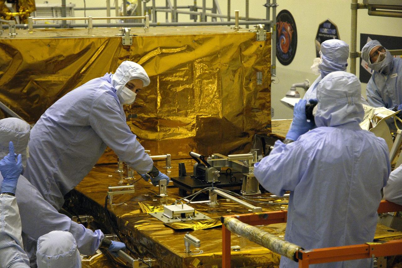 CAPE CANAVERAL, Fla. –   In the Payload Hazardous Servicing Facility at NASA’s Kennedy Space Center, crew members with the STS-125 mission get a close look at some of the equipment associated with their mission to service NASA’s Hubble Space Telescope. At left is Mission Specialist Mike Massimino reaching out to equipment on the Main Electronics Box, or MEB. The STS-125 crew is taking part in a crew equipment interface test, which provides experience handling tools, equipment and hardware they will use on their mission.  Space shuttle Atlantis is targeted to launch on the STS-125 mission Oct. 10. Photo credit: NASA/Kim Shiflett