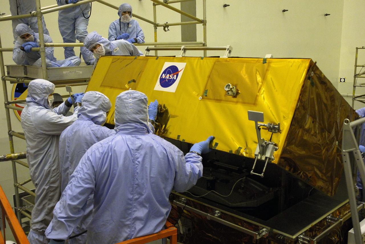 CAPE CANAVERAL, Fla. –   In the Payload Hazardous Servicing Facility at NASA’s Kennedy Space Center, crew members with the STS-125 mission get a close look at some of the equipment associated with their mission to service NASA’s Hubble Space Telescope. From left, Mission Specialists John Grunsfeld and Mike Massimino, with the help of a technician, open the Fine Guidance Sensor Scientific Instrument Protective Enclosure, or FSIPE, to look at the Fine Guidance Sensor.  The STS-125 crew is taking part in a crew equipment interface test, which provides experience handling tools, equipment and hardware they will use on their mission.  Space shuttle Atlantis is targeted to launch on the STS-125 mission Oct. 10. Photo credit: NASA/Kim Shiflett