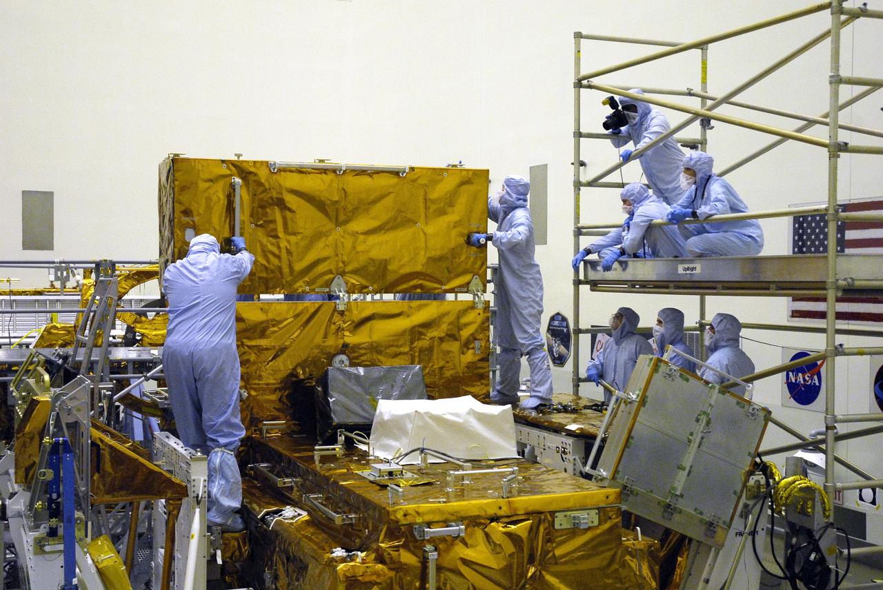 CAPE CANAVERAL, Fla. –  In the Payload Hazardous Servicing Facility at NASA’s Kennedy Space Center, crew members with the STS-125 mission get a close look at some of the equipment associated with their mission to service NASA’s Hubble Space Telescope.  Here, technicians prepare to close the Fine Guidance Sensor Scientific Instrument Protective Enclosure, or FSIPE. The STS-125 crew is taking part in a crew equipment interface test, which provides experience handling tools, equipment and hardware they will use on their mission.  Space shuttle Atlantis is targeted to launch on the STS-125 mission Oct. 10. Photo credit: NASA/Kim Shiflett