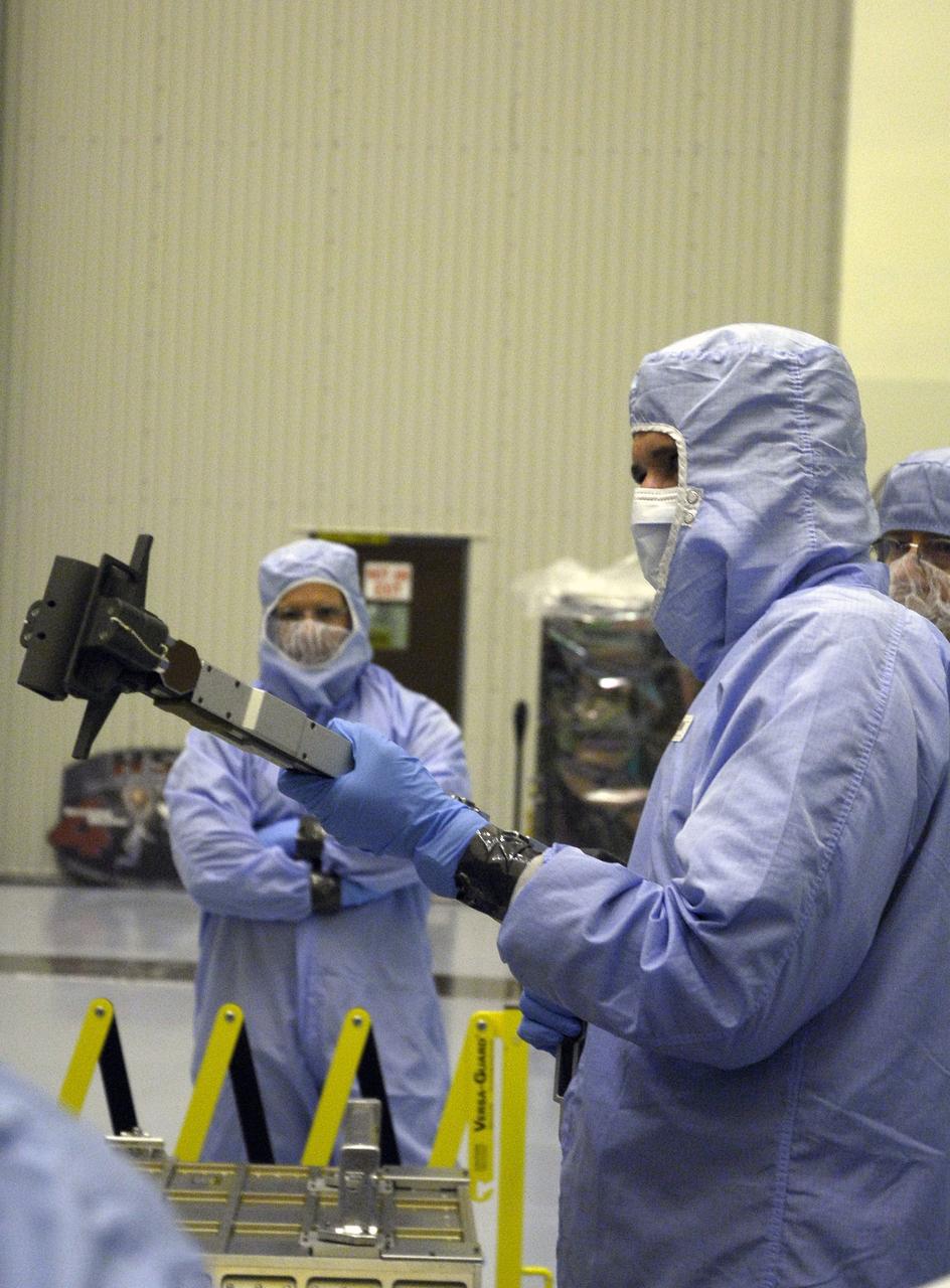 CAPE CANAVERAL, Fla. –   In the Payload Hazardous Servicing Facility at NASA’s Kennedy Space Center, crew members with the STS-125 mission get a close look at some of the equipment associated with their mission to service NASA’s Hubble Space Telescope.  At right is Mission Specialist John Grunsfeld, handling the RSU change-out tool from the Small ORU Protective Enclosure, or SOPE. Behind him, at right, is Johnson Space Center EVA Trainer Ron Sheffield.  The STS-125 crew is taking part in a crew equipment interface test, which provides experience handling tools, equipment and hardware they will use on their mission.  Space shuttle Atlantis is targeted to launch on the STS-125 mission Oct. 10. Photo credit: NASA/Kim Shiflett