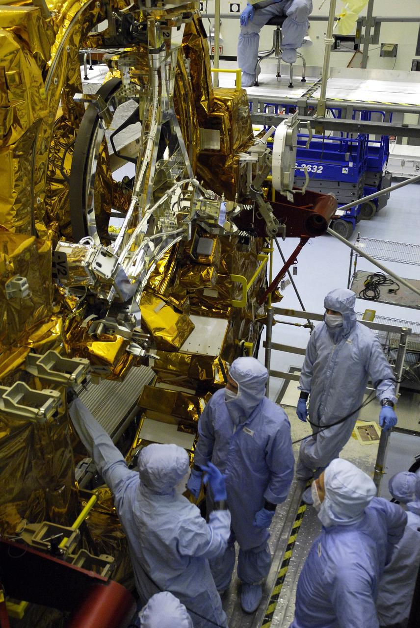 CAPE CANAVERAL, Fla. –  In the Payload Hazardous Servicing Facility at NASA’s Kennedy Space Center, crew members with the STS-125 mission get a close look at some of the equipment associated with their mission to service NASA’s Hubble Space Telescope.  A technician, at left, provides information about the Soft Capture Mechanism on the Flight Support Structure to Mission Specialists Michael Good, Andrew Feustel and Mike Massimino. The mechanism will enable the future rendezvous, capture and safe disposal of NASA's Hubble Space Telescope by either a crewed or robotic mission. The ring-like device attaches to Hubble’s aft bulkhead. The STS-125 crew is taking part in a crew equipment interface test, which provides experience handling tools, equipment and hardware they will use on their mission.  Space shuttle Atlantis is targeted to launch on the STS-125 mission Oct. 10. Photo credit: NASA/Kim Shiflett