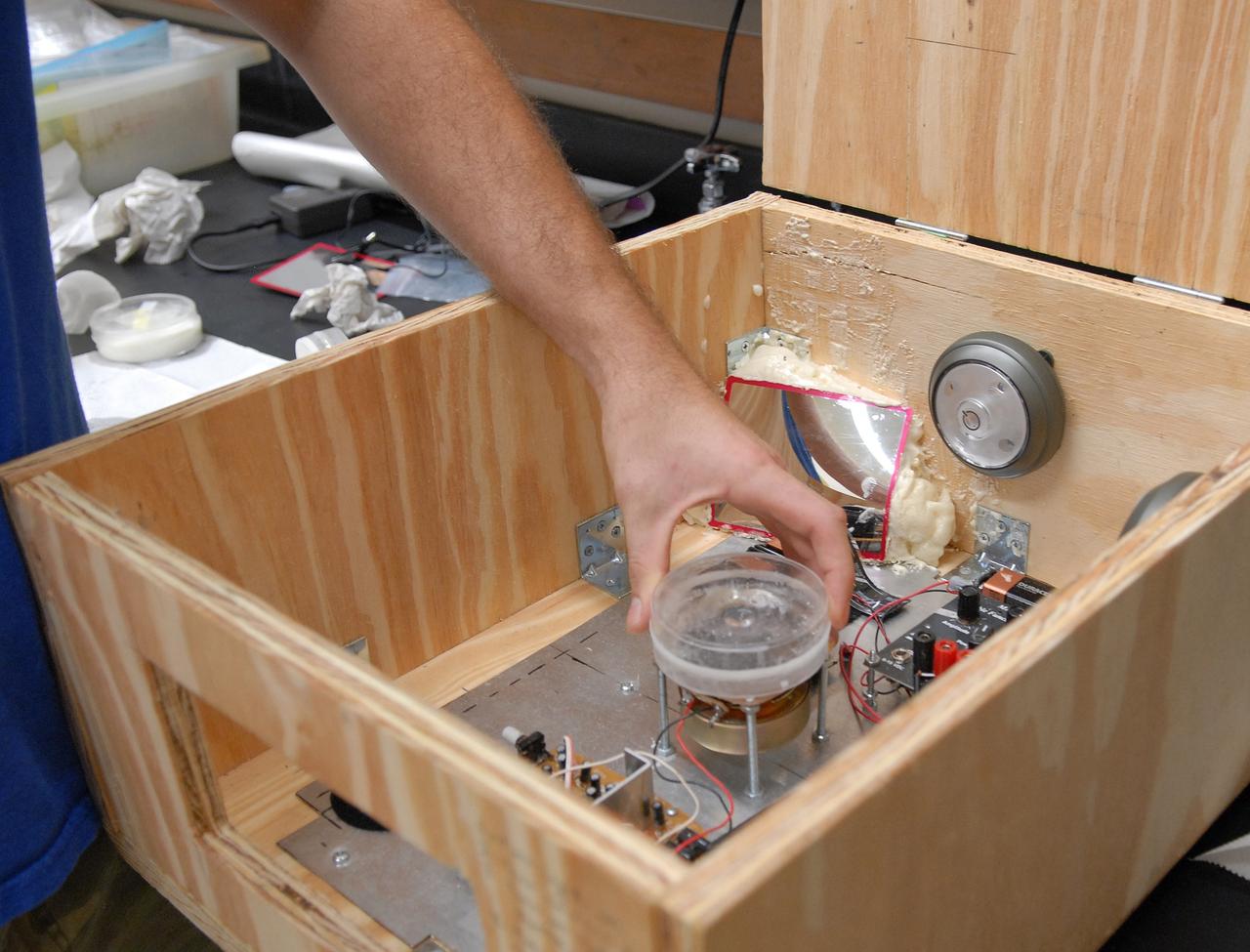 CAPE CANAVERAL, Fla. –  Experiments are placed inside the FASTRACK Space Experiment Platform viewed in the Life Science Building at NASA's Kennedy Space Center. The space experiment rack is under development for flight aboard NASA's first commercially-provided research flights on Zero Gravity Corporation's reduced gravity aircraft. It is being developed jointly by Kennedy and Space Florida to facilitate NASA and commercial use of reusable U.S. suborbital flight vehicles currently under development. FASTRACK will enable investigators to test experiments, apparatus and analytical techniques in hardware compatible with the International Space Station, and to perform science that can be carried out during the reduced gravity available for brief periods during aircraft parabolas. Flight testing of the FASTRACK will be performed on four consecutive days between September 9-12 from Ellington Field near NASA's Johnson Space Center, Houston.  Photo credit: NASA/Troy Cryder