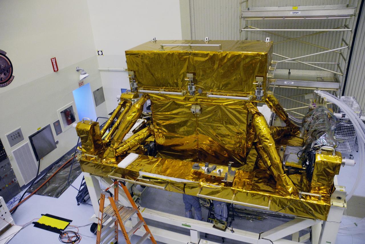CAPE CANAVERAL, Fla. – Components comprising the payload for space shuttle Atlantis on the STS-125 mission to service the Hubble Space Telescope are on display in the Payload Hazardous Servicing Facility at NASA's Kennedy Space Center. Seen here is the box containing the Cosmic Origins Spectrograph, or COS, on the orbital replacement unit carrier. Over 11 days and five spacewalks, Atlantis’ crew will make repairs and upgrades to the telescope, leaving it better than ever and ready for at least another five years – or more – of research. Launch of Atlantis is targeted for Oct. 10. Photo credit: NASA/Troy Cryder