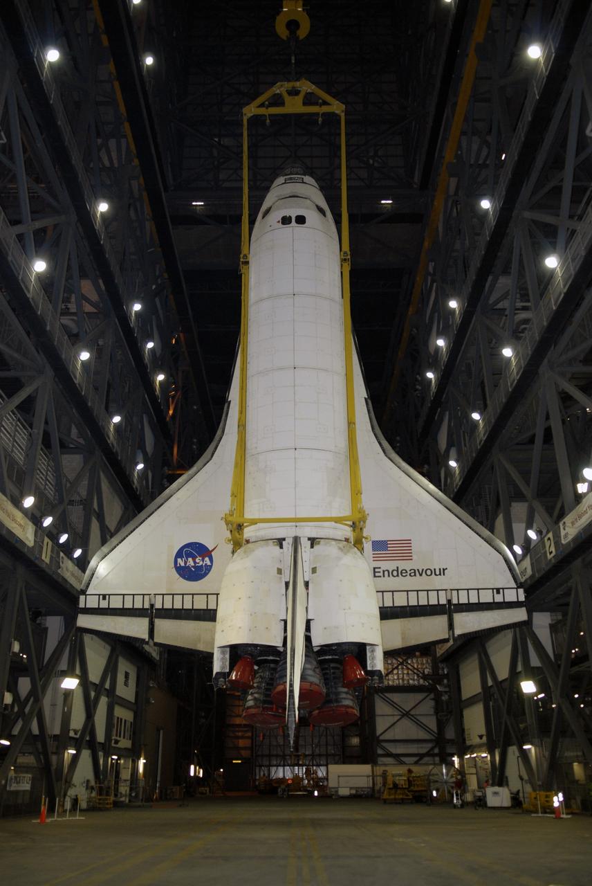 CAPE CANAVERAL, Fla. - Suspended over the transfer aisle of the Vehicle Assembly Building at NASA’s Kennedy Space Center, space shuttle Endeavour is slowly lifted into the upper levels for transfer into high bay 1 for mating with its external fuel tank and solid rocket boosters. After additional preparations are made, the shuttle will be rolled out to Launch Pad 39B. Endeavour is designated the rescue spacecraft for space shuttle Atlantis’ STS-125 mission to NASA’s Hubble Space Telescope, targeted for October. After Atlantis has safely returned from its flight, Endeavour will be moved to Launch Pad 39A for its STS-126 mission to the International Space Station, targeted for November. Photo credit: NASA/Kim Shiflett