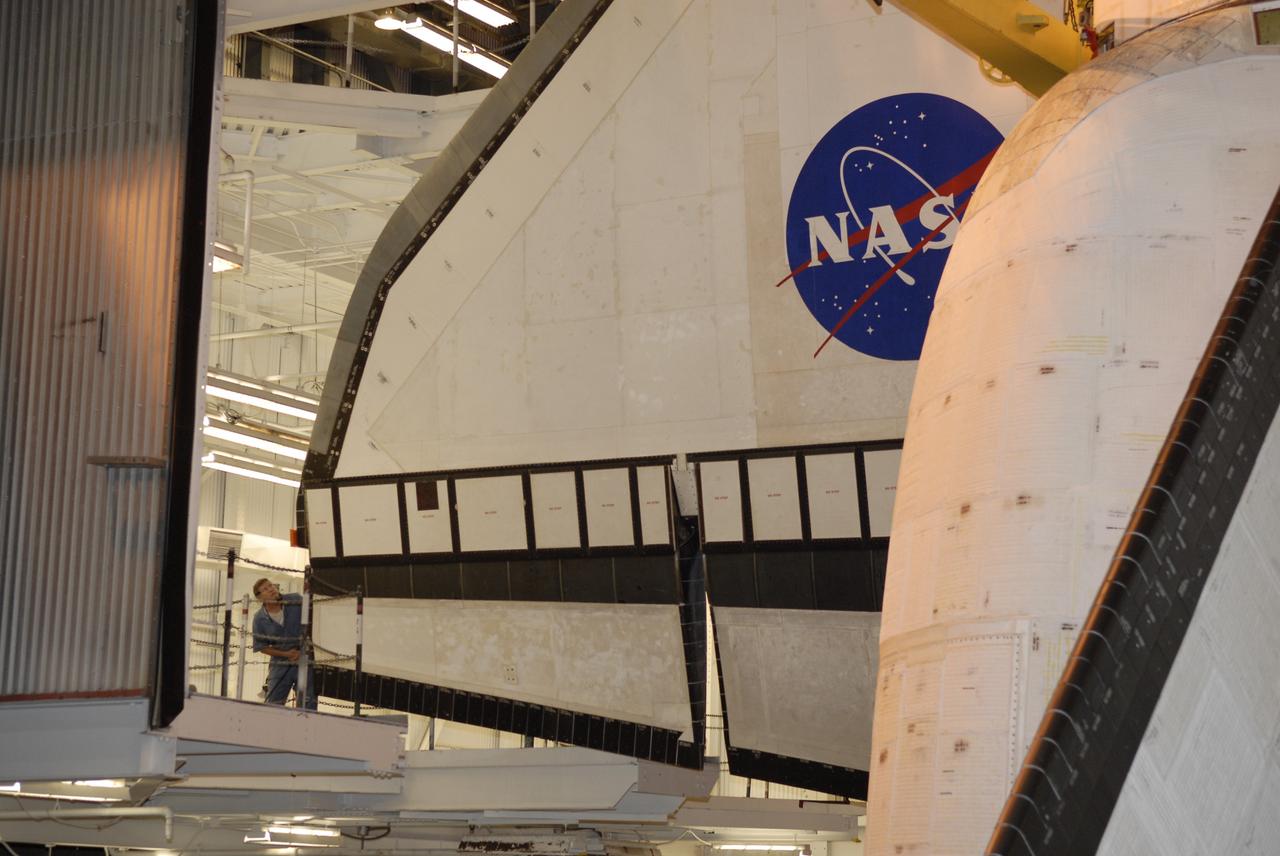 CAPE CANAVERAL, Fla. - At NASA’s Kennedy Space Center, a technician (lower left) monitors the progress of space shuttle Endeavour as it is lowered into high bay 1 of the Vehicle Assembly Building for mating with its external fuel tank and solid rocket boosters, waiting below. After additional preparations are made, the shuttle will be rolled out to Launch Pad 39B. Endeavour is designated the rescue spacecraft for space shuttle Atlantis’ STS-125 mission to NASA’s Hubble Space Telescope, targeted for October. After Atlantis has safely returned from its flight, Endeavour will be moved to Launch Pad 39A for its STS-126 mission to the International Space Station, targeted for November. Photo credit: NASA/Kim Shiflett