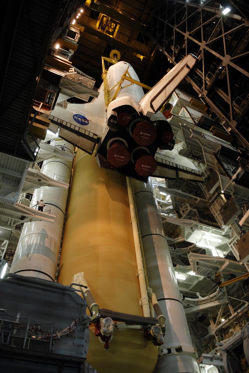 CAPE CANAVERAL, Fla. - In high bay 1 of the Vehicle Assembly Building at NASA’s Kennedy Space Center, space shuttle Endeavour is lowered alongside its external fuel tank and solid rocket boosters for mating. After additional preparations are made, the shuttle will be rolled out to Launch Pad 39B. Endeavour is designated the rescue spacecraft for space shuttle Atlantis’ STS-125 mission to NASA’s Hubble Space Telescope, targeted for October. After Atlantis has safely returned from its flight, Endeavour will be moved to Launch Pad 39A for its STS-126 mission to the International Space Station, targeted for November. Photo credit: NASA/Kim Shiflett
