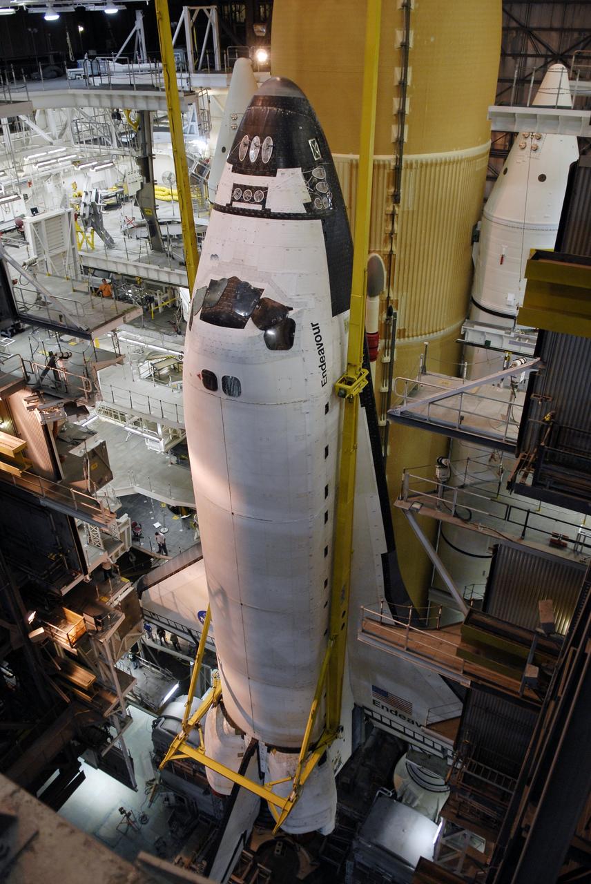 CAPE CANAVERAL, Fla. - In high bay 1 of the Vehicle Assembly Building at NASA’s Kennedy Space Center, space shuttle Endeavour is lowered alongside its external fuel tank and solid rocket boosters for mating. After additional preparations are made, the shuttle will be rolled out to Launch Pad 39B. Endeavour is designated the rescue spacecraft for space shuttle Atlantis’ STS-125 mission to NASA’s Hubble Space Telescope, targeted for October. After Atlantis has safely returned from its flight, Endeavour will be moved to Launch Pad 39A for its STS-126 mission to the International Space Station, targeted for November. Photo credit: NASA/Kim Shiflett