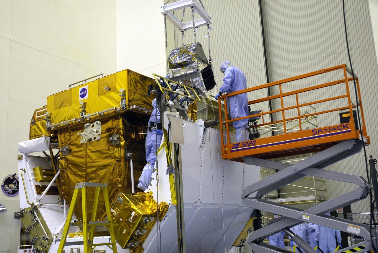 CAPE CANAVERAL, Fla. -  In the Payload Hazardous Servicing Facility at NASA’s Kennedy Space Center, technicians monitor the movement of an IMAX 3D camera as it is lowered onto the Orbital Replacement Unit Carrier, or ORUC, to be installed in space shuttle Atlantis’ payload bay. Other equipment on the ORUC are the Fine Guidance Sensor Scientific Instrument Protective Enclosure and the Fine Guidance Sensor. The camera will record the STS-125 mission to service the Hubble Space Telescope. Over 11 days and five spacewalks,  Atlantis’ crew will make repairs and upgrades to the telescope, leaving it better than ever and ready for at least another five years – or more – of research.  Launch of Atlantis is targeted for Oct. 10.  Photo credit: NASA/Jack Pfaller