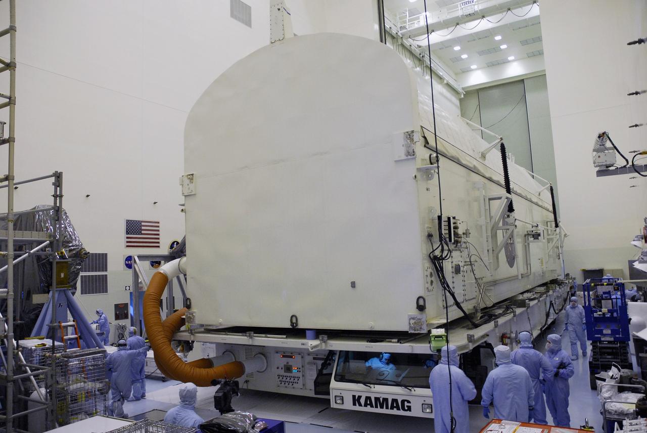 CAPE CANAVERAL, Fla. -  The payload canister backs into the Payload Hazardous Servicing Facility at NASA’s Kennedy Space Center.  The equipment and carriers associated with the STS-125 mission to service the Hubble Space Telescope will be installed in the canister for transfer to Launch Pad 39A. The canister contains an environmental control system, signified by the red umbilical lines at left.  At the pad, the carriers will be loaded into space shuttle Atlantis’ payload bay.  Launch of Atlantis is targeted for Oct. 10. Photo credit: NASA/Cory Huston