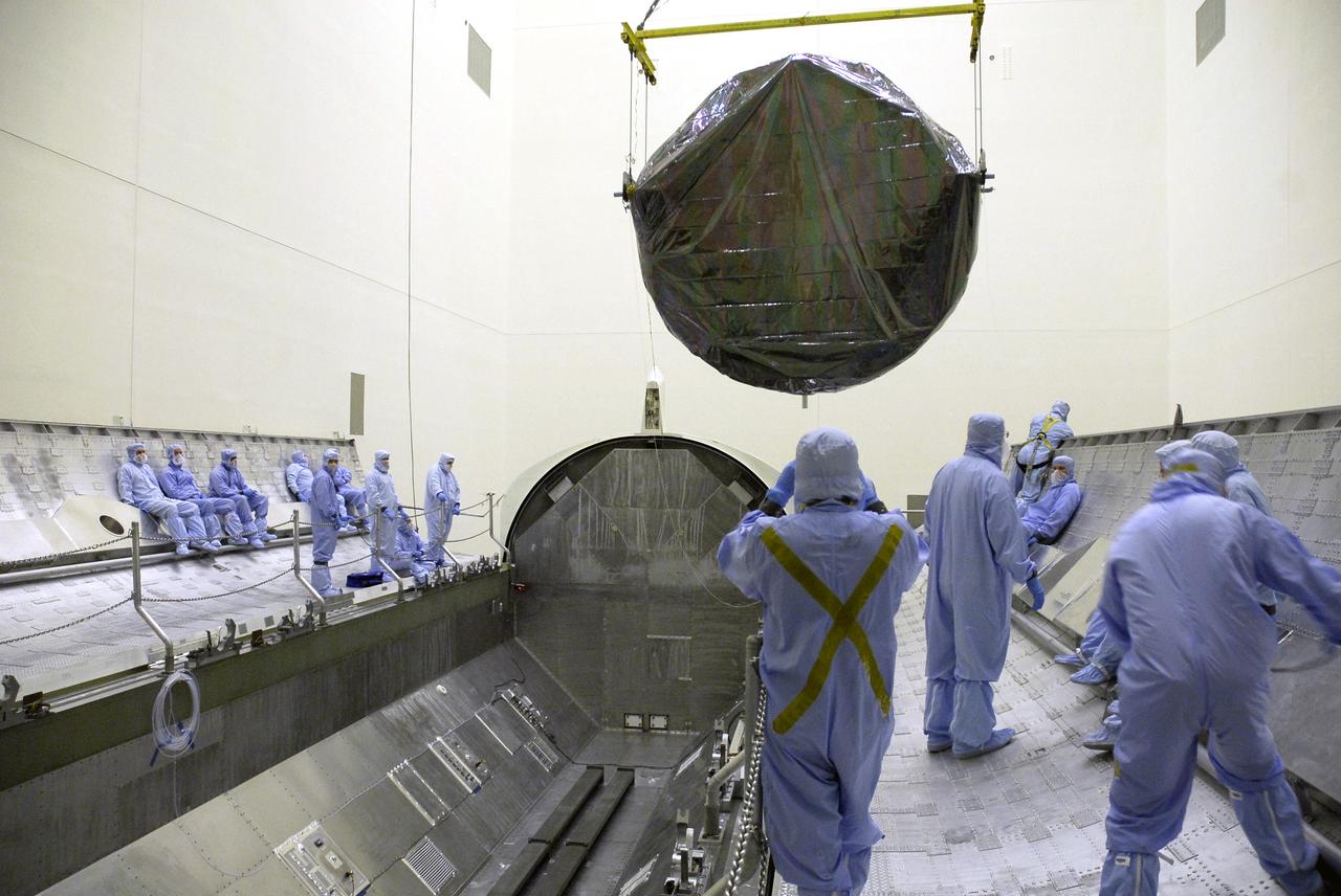 CAPE CANAVERAL, Fla. - In the Payload Hazardous Servicing Facility at NASA’s Kennedy Space Center, workers observe the movement of the crane holding the Flight Support System carrier with the Soft Capture Mechanism. It will be installed in the payload canister for transfer to Launch Pad 39A. The carrier is one of four associated with the STS-125 mission to service the Hubble Space Telescope. At the pad, all the carriers will be loaded into space shuttle Atlantis’ payload bay. Launch of Atlantis is targeted for Oct. 10. Photo credit: NASA/Cory Huston