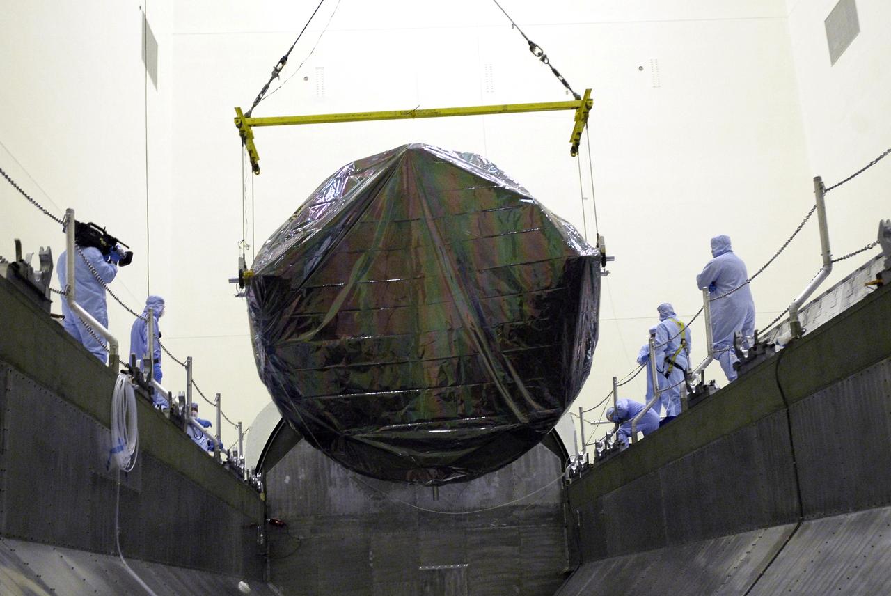 CAPE CANAVERAL, Fla. - In the Payload Hazardous Servicing Facility at NASA’s Kennedy Space Center, the overhead crane lowers the Flight Support System carrier with the Soft Capture Mechanism into the payload canister. The canister will transfer the carrier to Launch Pad 39A. The carrier is one of four associated with the STS-125 mission to service the Hubble Space Telescope. At the pad, all the carriers will be loaded into space shuttle Atlantis’ payload bay. Launch of Atlantis is targeted for Oct. 10. Photo credit: NASA/Cory Huston